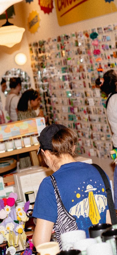Shoppers exploring a vibrant selection of locally made goods, candles, keychains, and more.