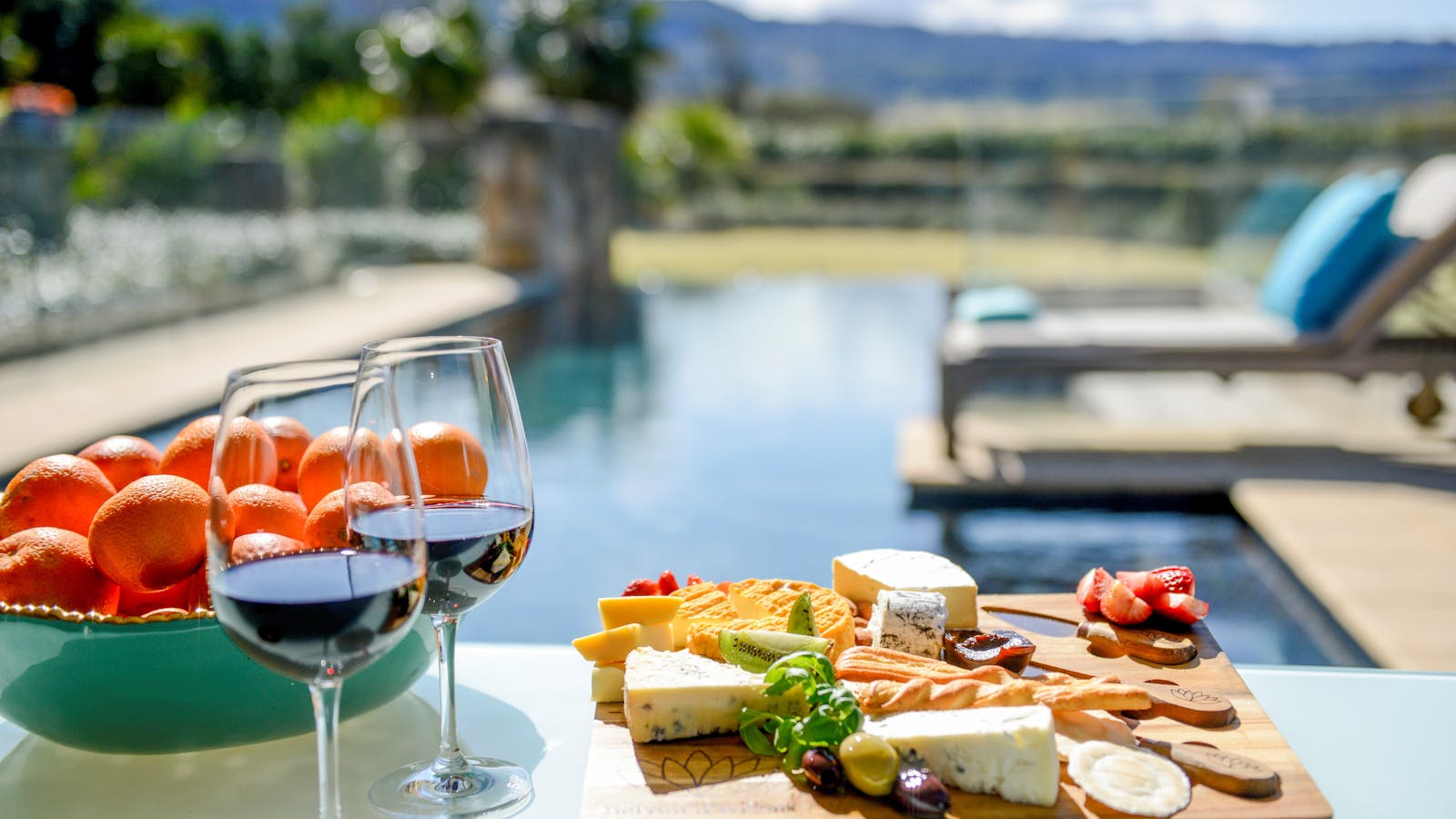 Why not relax poolside with a delicious cheese platter and wine!  Sounds good to me.
