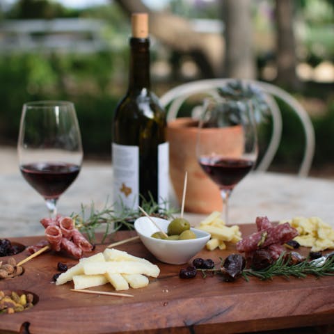 Wine and cheese placed on a table to enjoy