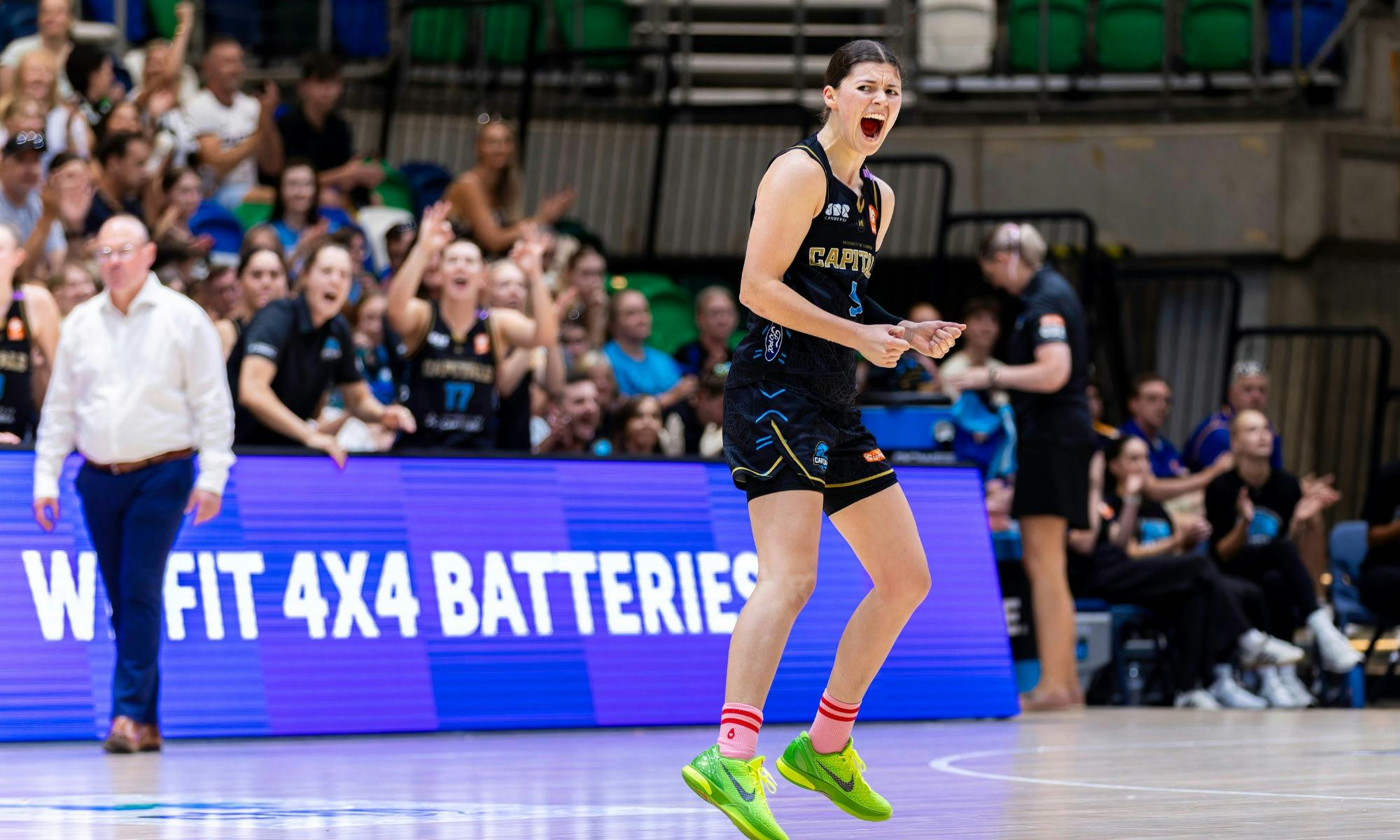 UC Capitals player celebrates on the court after scoring.