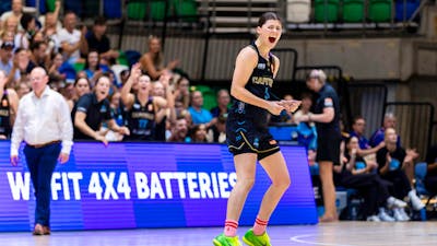 UC Capitals player celebrates on the court after scoring.