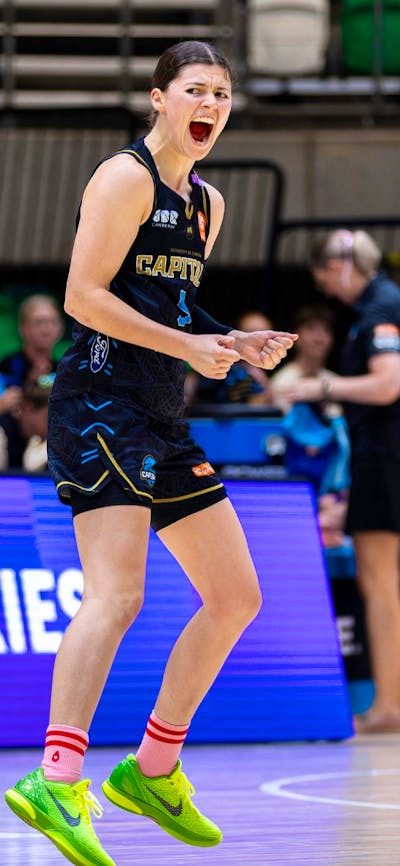 UC Capitals player celebrates on the court after scoring.