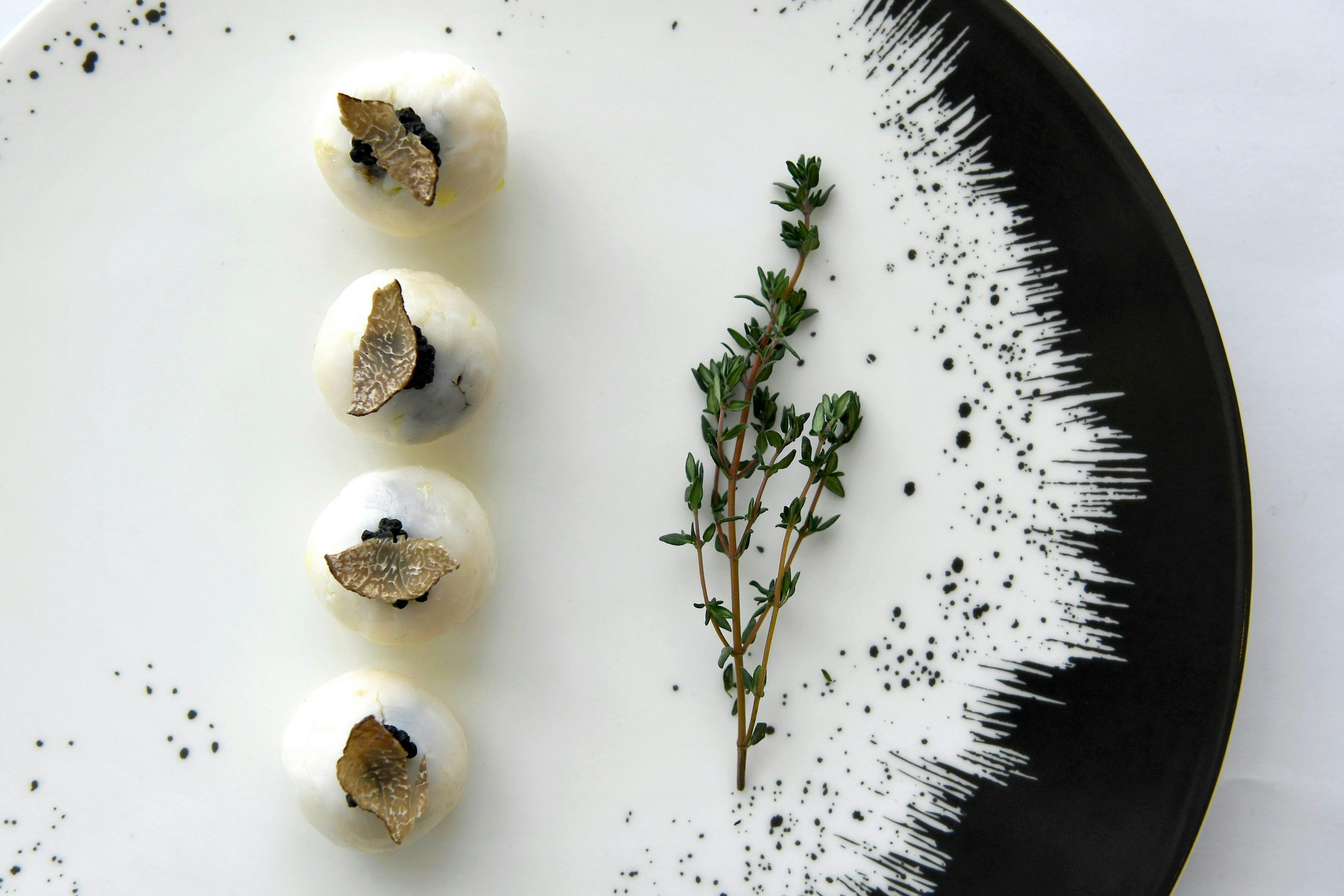 Plated dish featuring truffle and rosemary