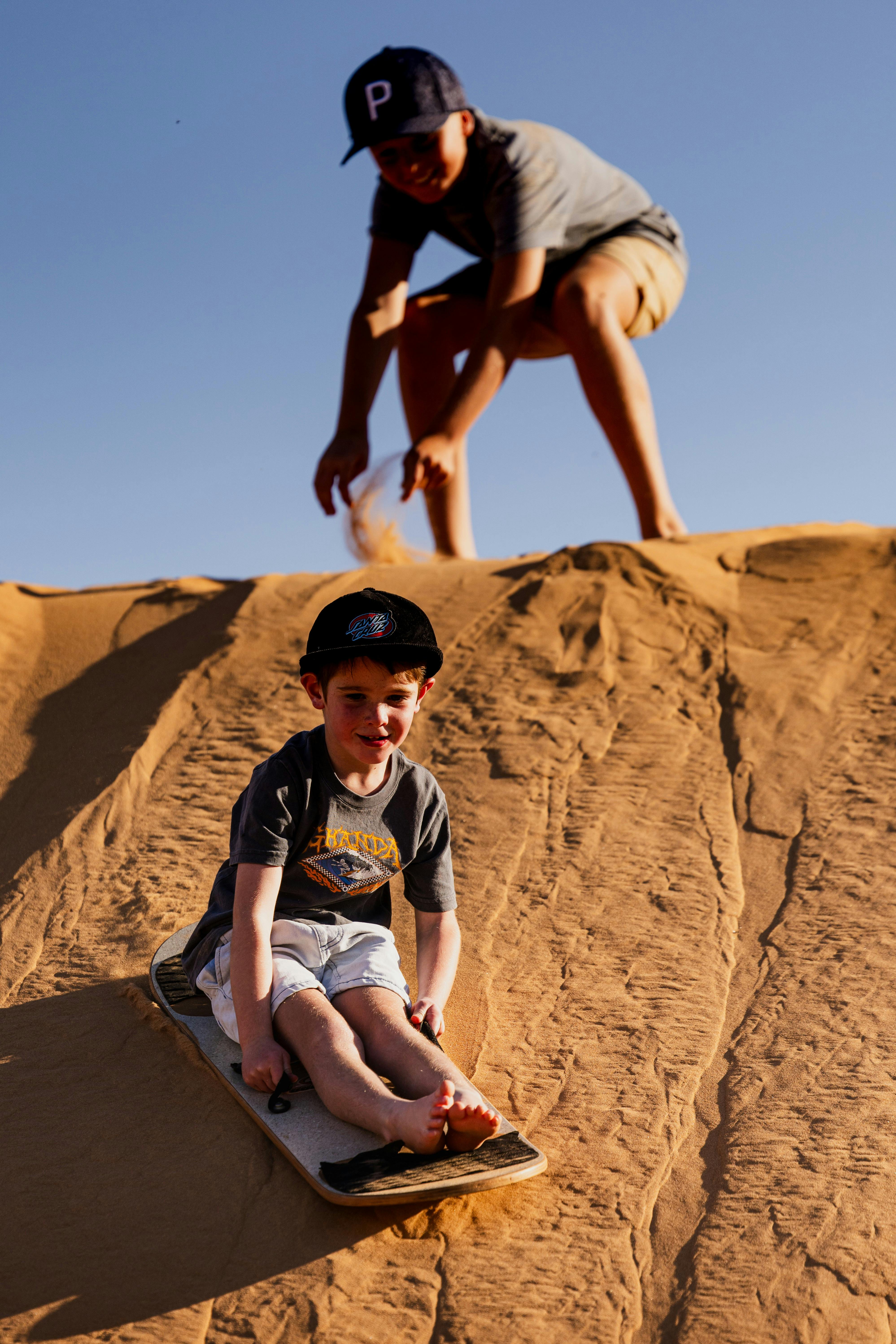 Children sandboarding