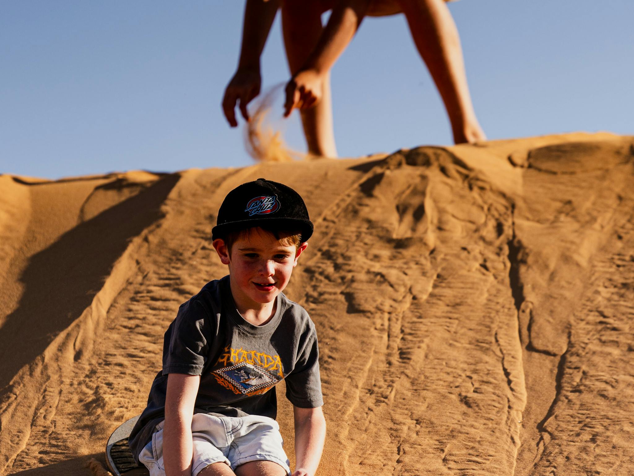 Children sandboarding