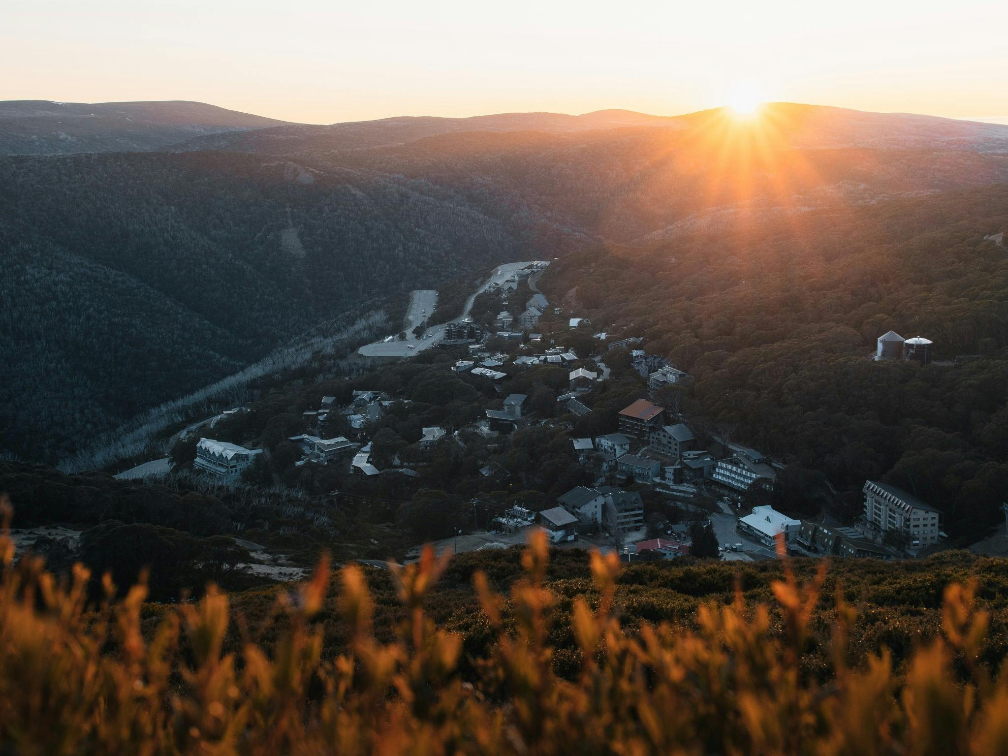 Top of the mountain looking upon the alpine village at sunrise