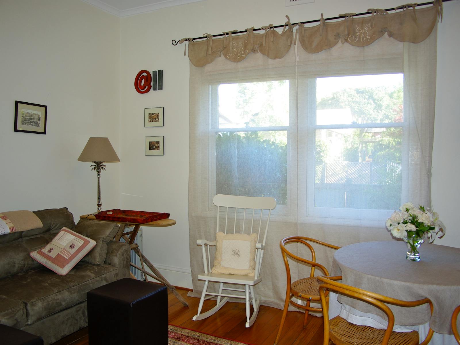 Sitting room with comfortable chairs, sun light and dining table