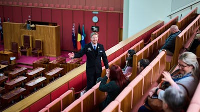 A guide shows visitors features of the Senate Chambers at Parliament House