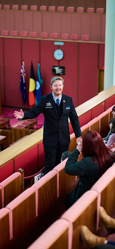 A guide shows visitors features of the Senate Chambers at Parliament House