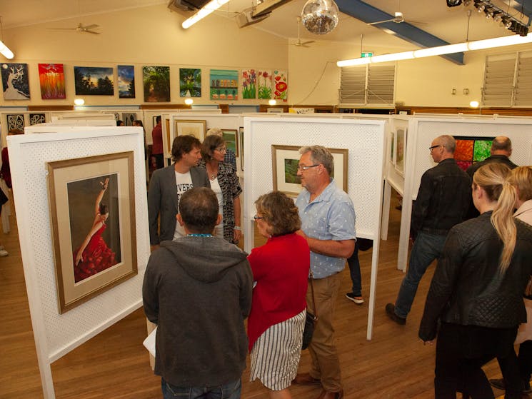 Wentworth Falls School Hall used as an art gallery. Art is displayed on Art Boards & adults browsing