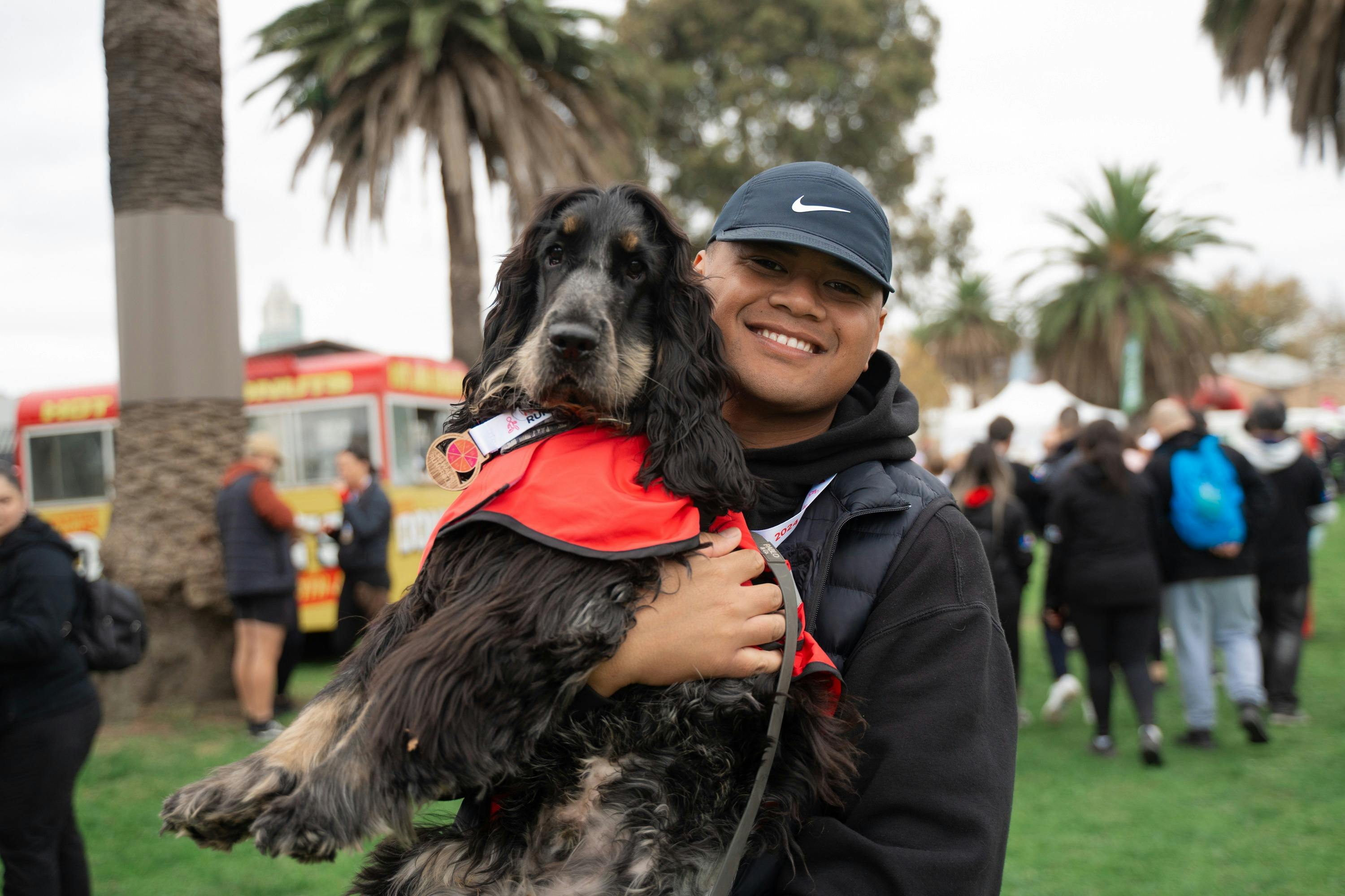 Man smiling, holding his dog