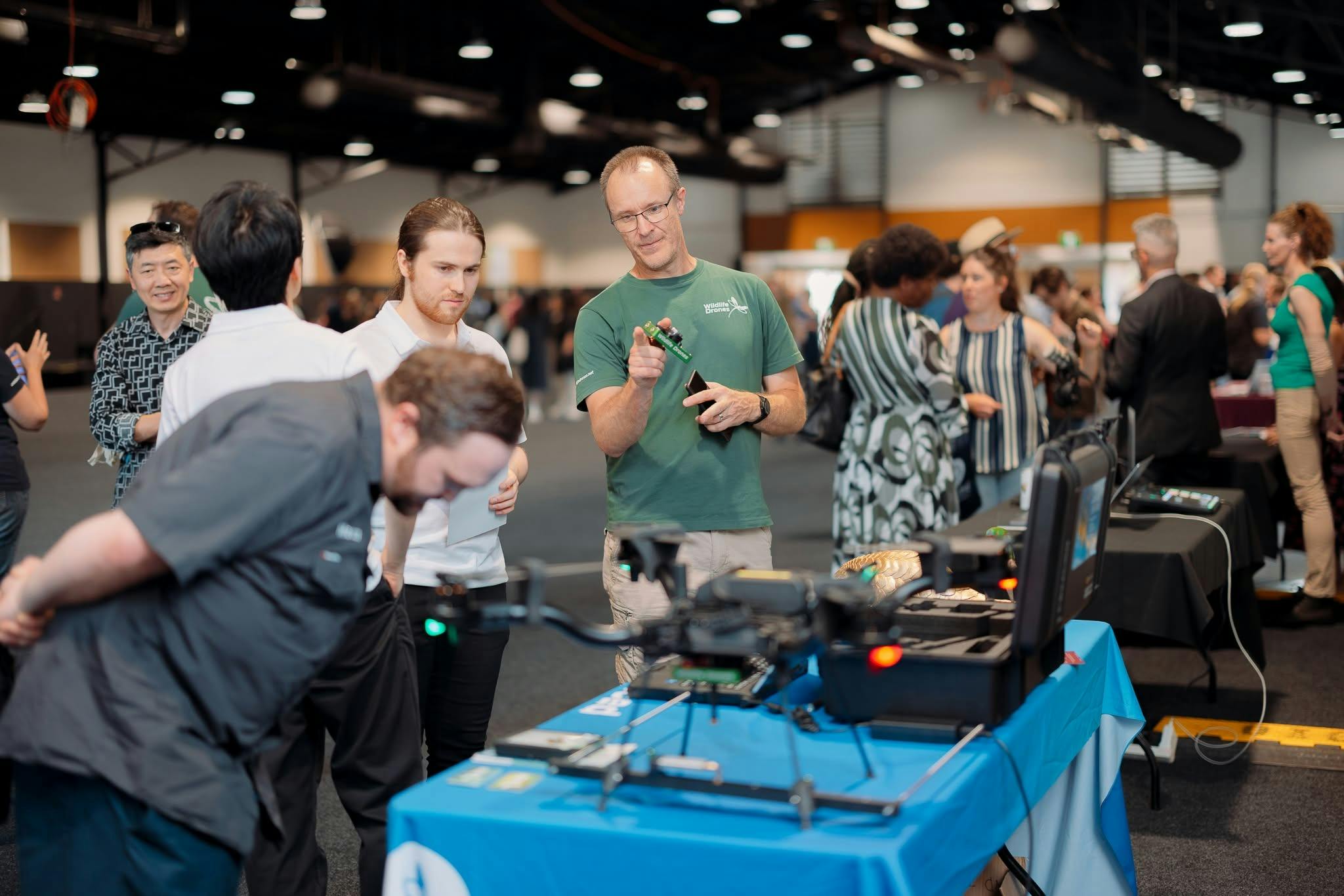 Tradestall from Innovaiton Showcase 2024, someone showing tech on a table at event