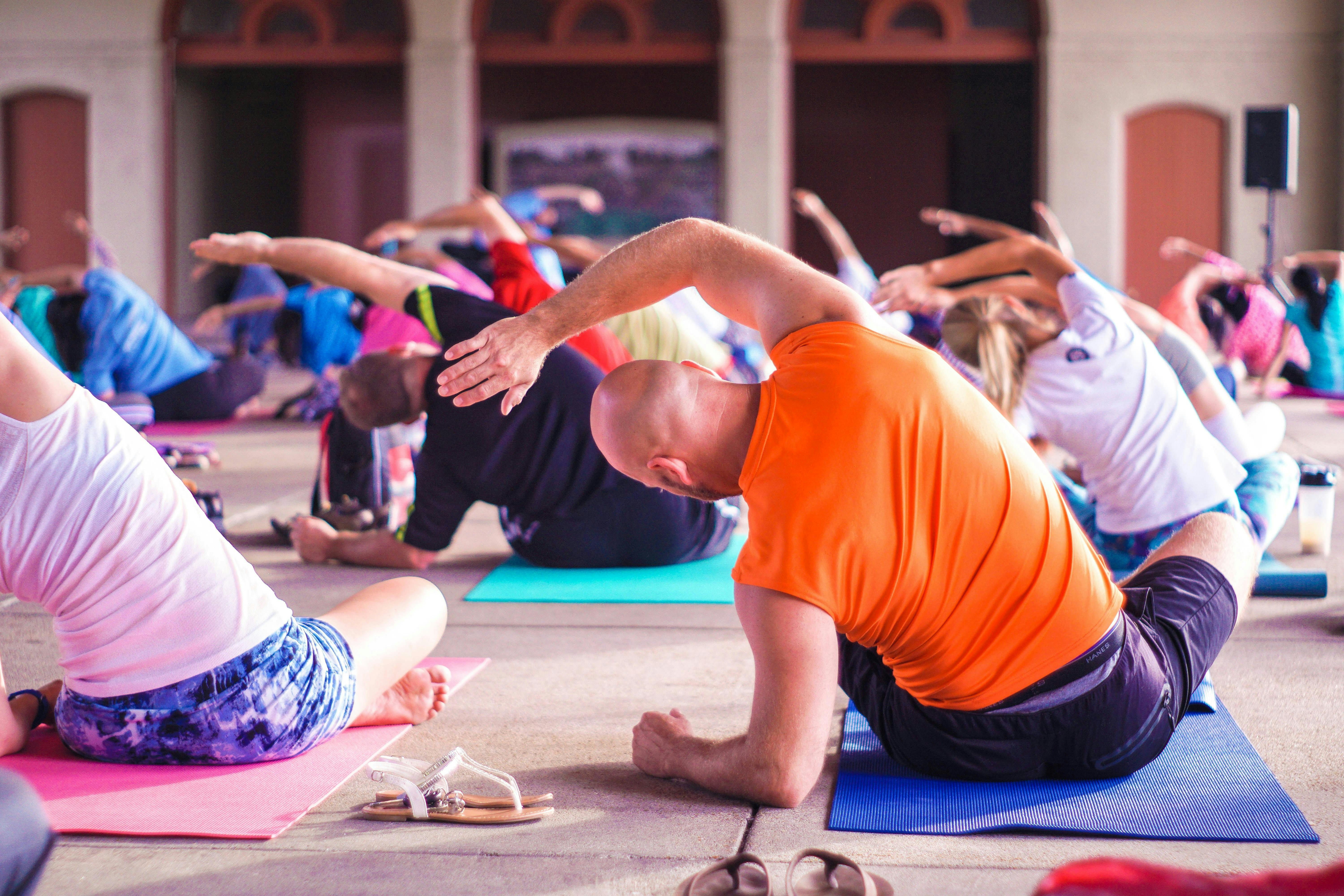 people doing yoga in bright clothes