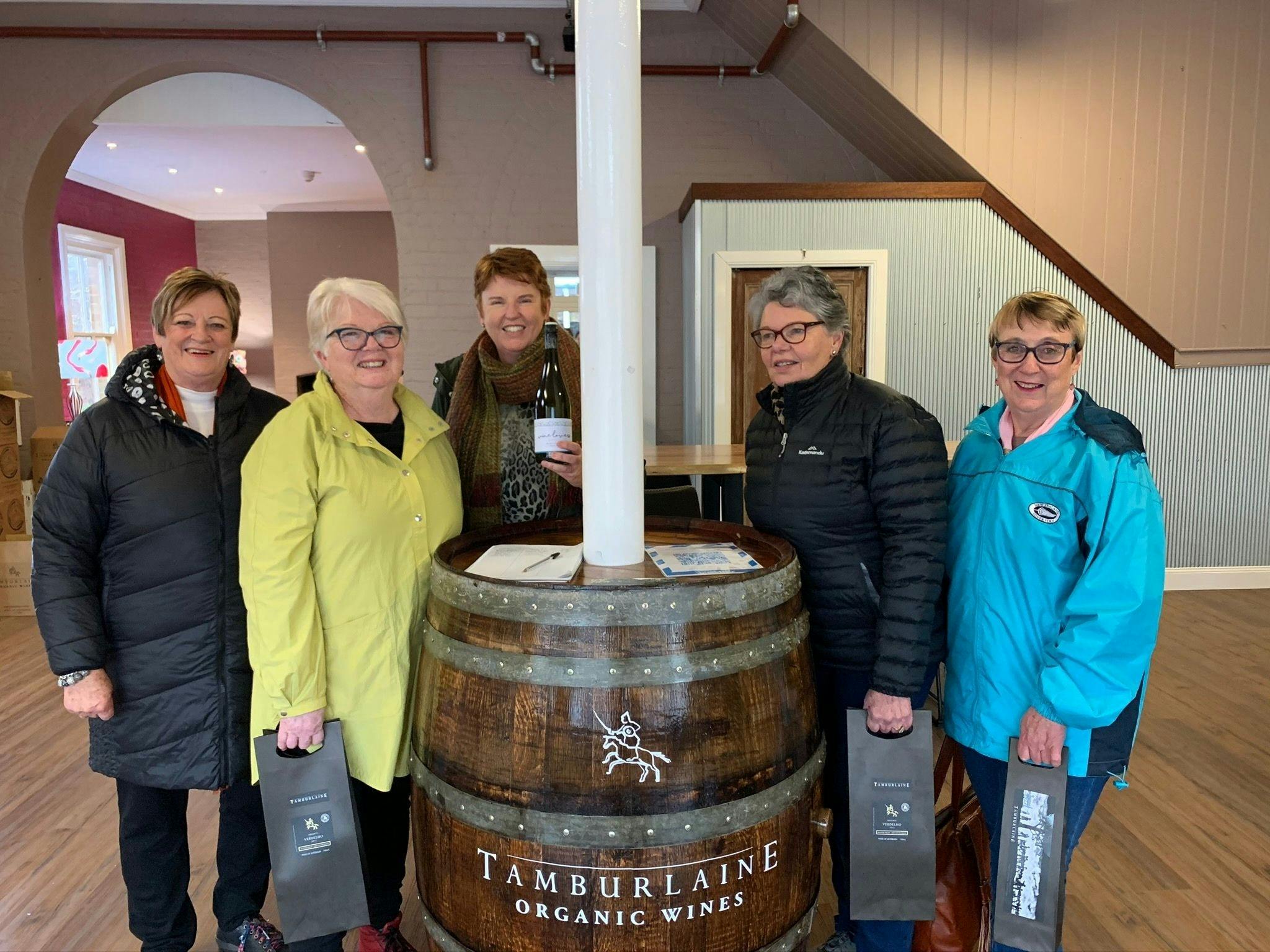 5 ladies in front of wine barrel