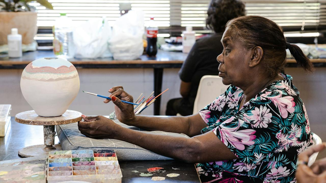 Artist Karen Inkamala paints her pot