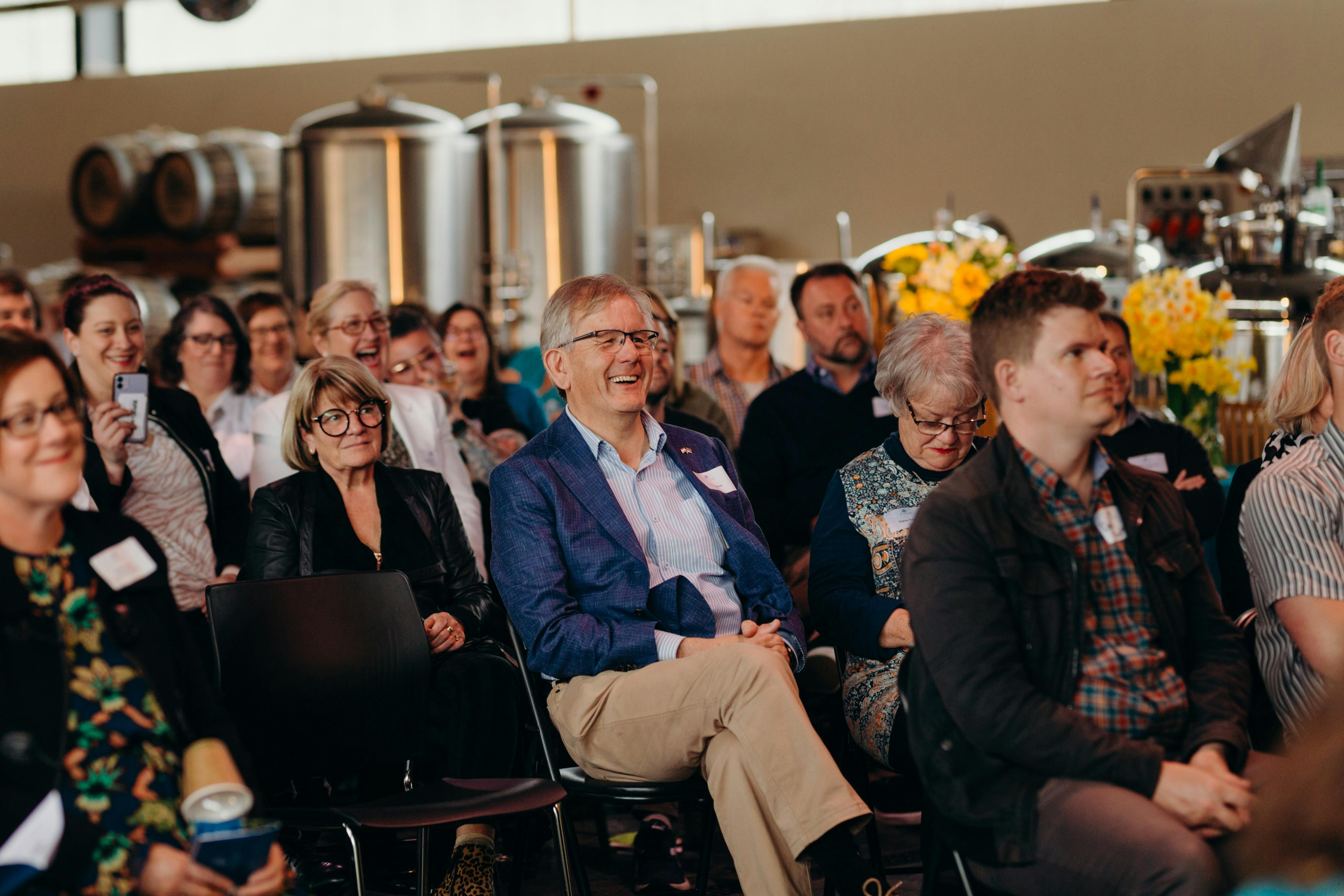 People sitting down watching a presentation at a corporate function at New Norfolk Distillery