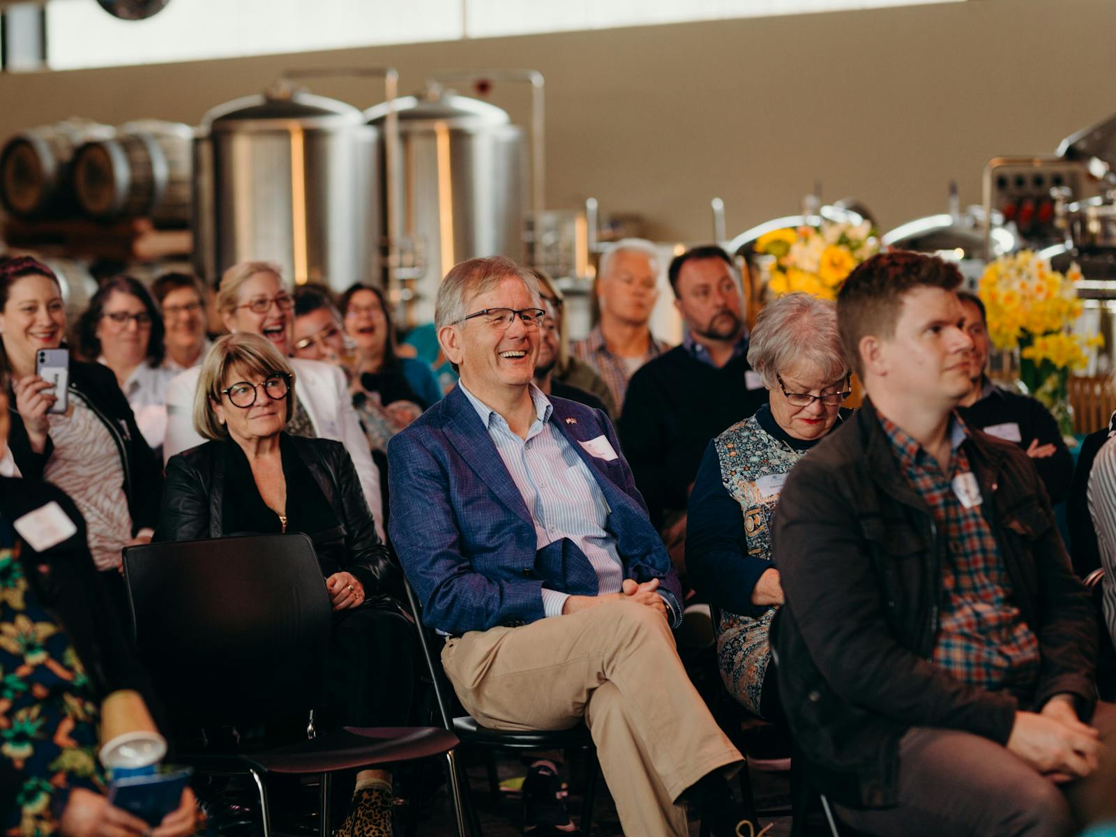 People sitting down watching a presentation at a corporate function at New Norfolk Distillery