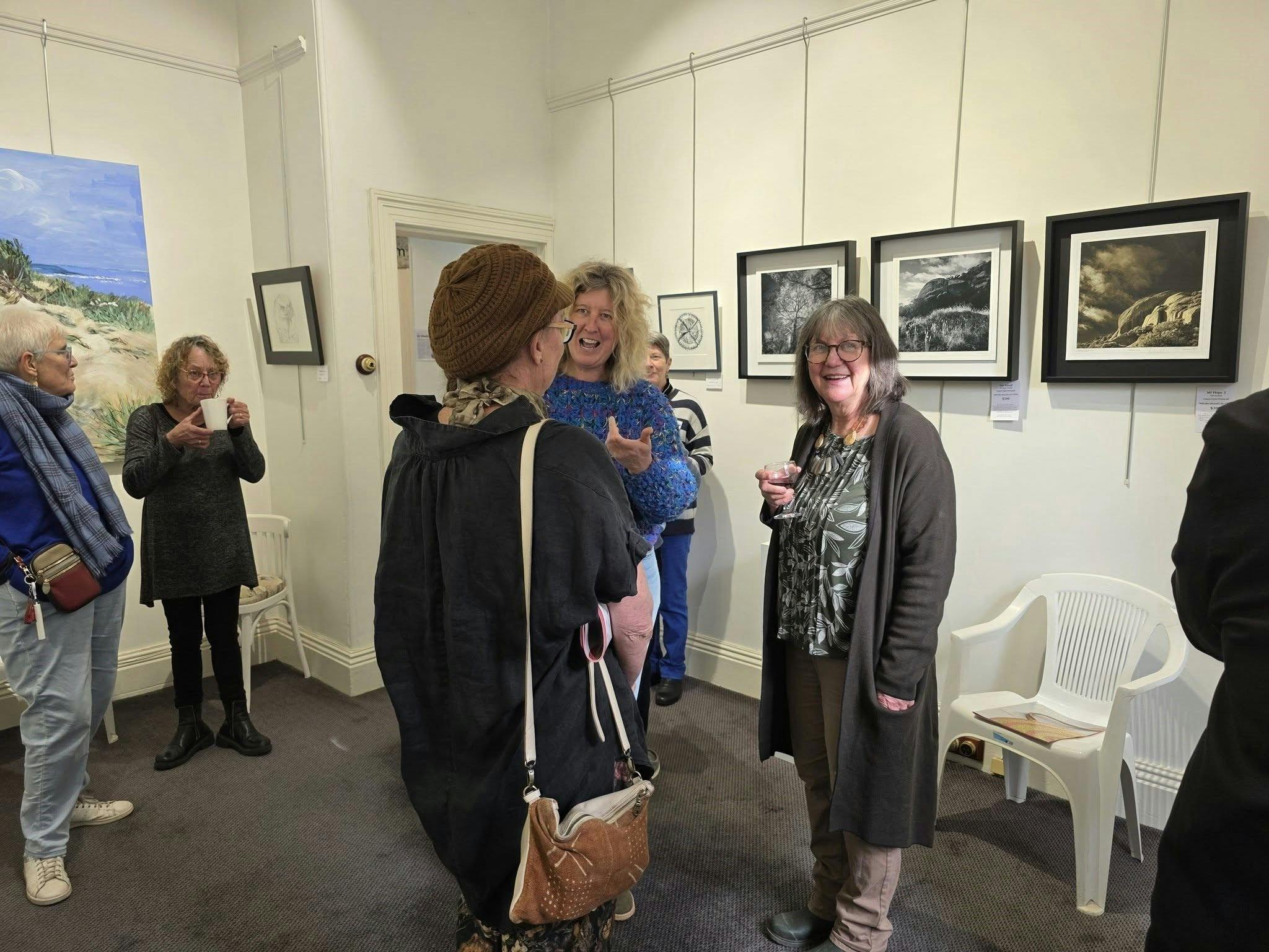 Gallery visitors enjoying conversation and refreshments