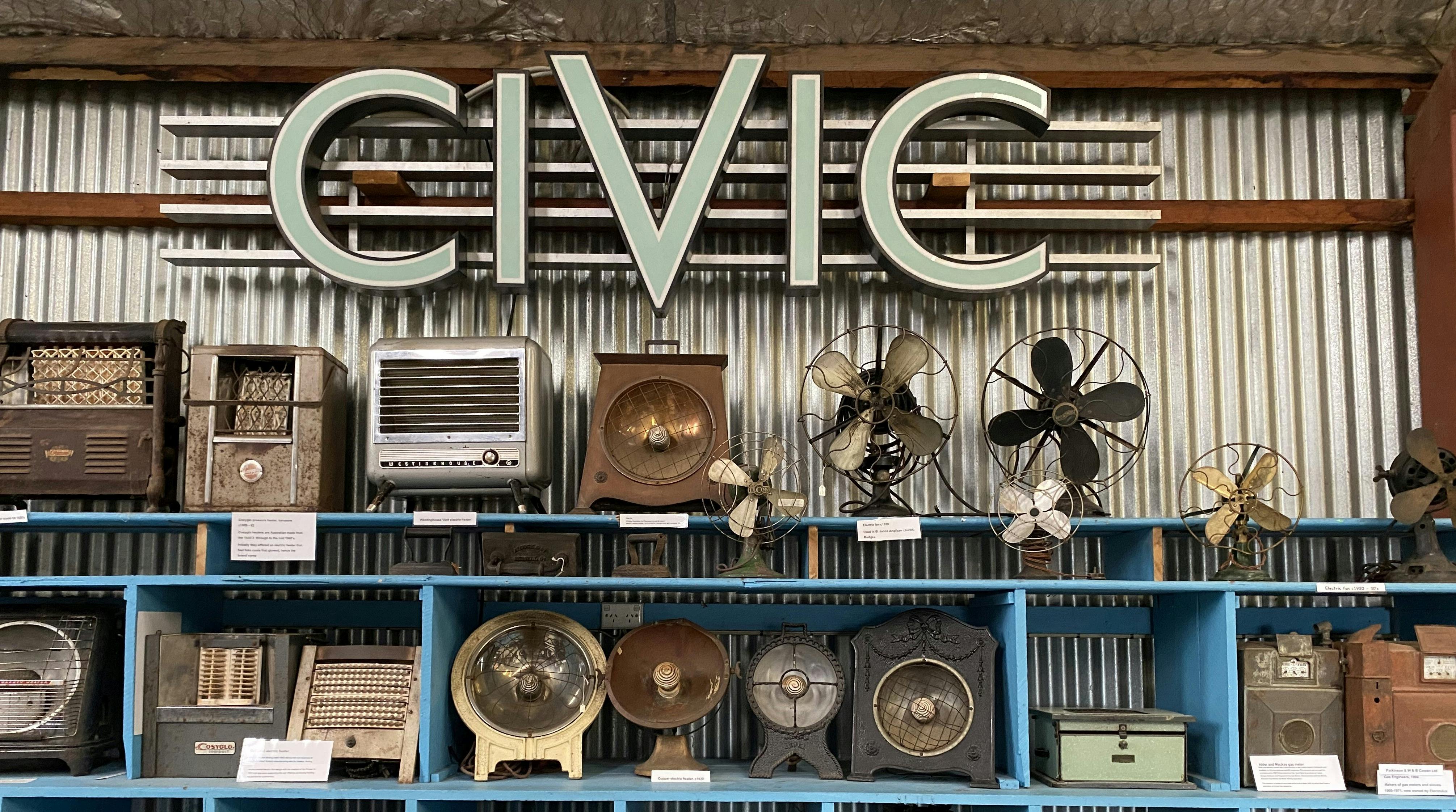 Civic theatre sign with collection of fans and heaters