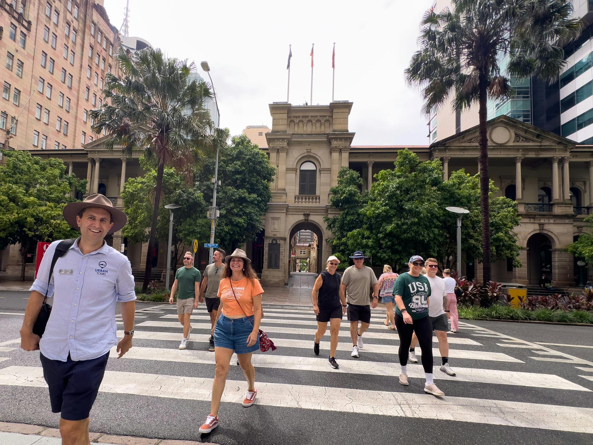Tour guide leading people across a zebra crossing Tour guide leading people across a zebra crossing