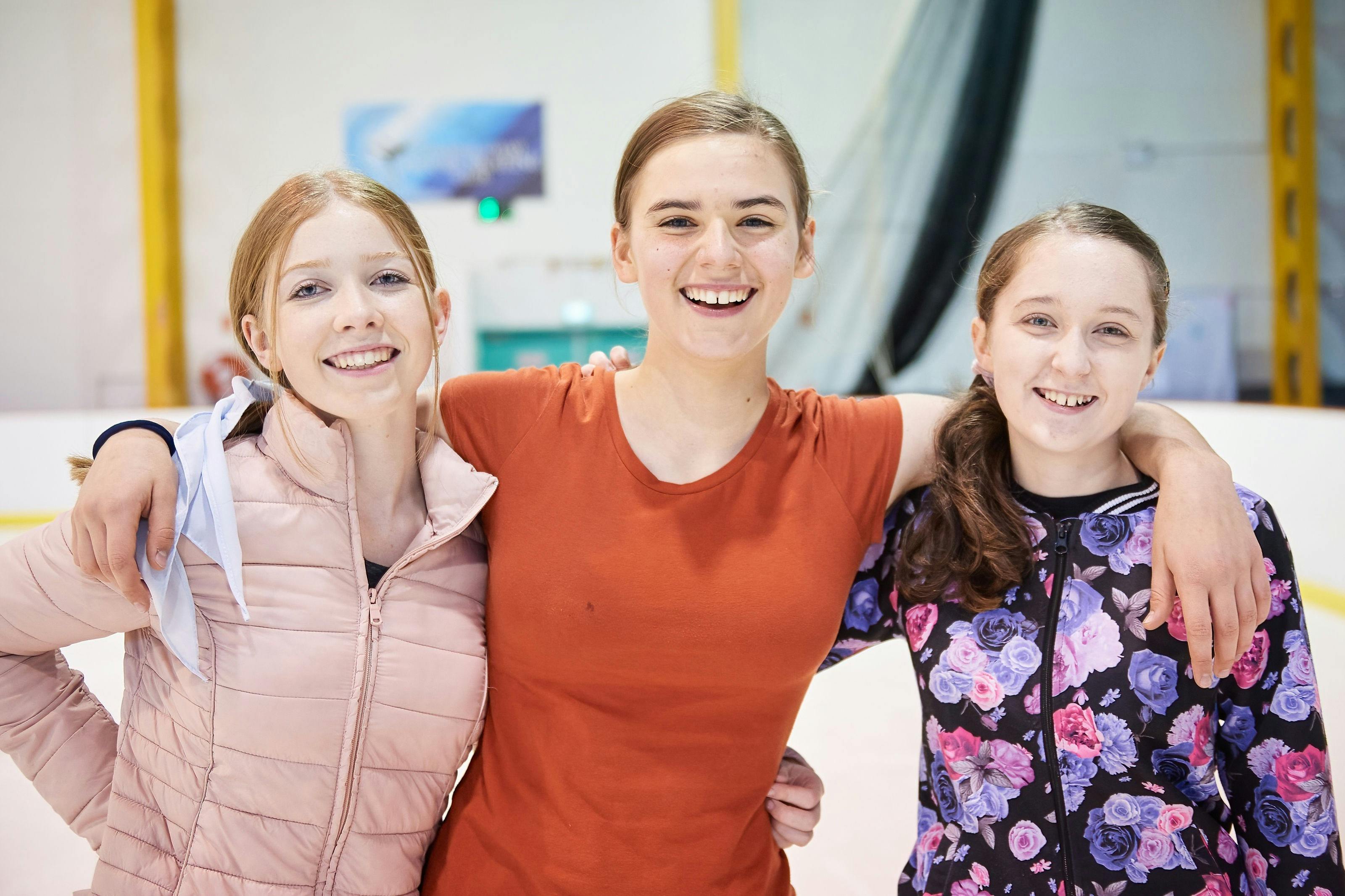 A close up of 3 teenagers posing for the camera.