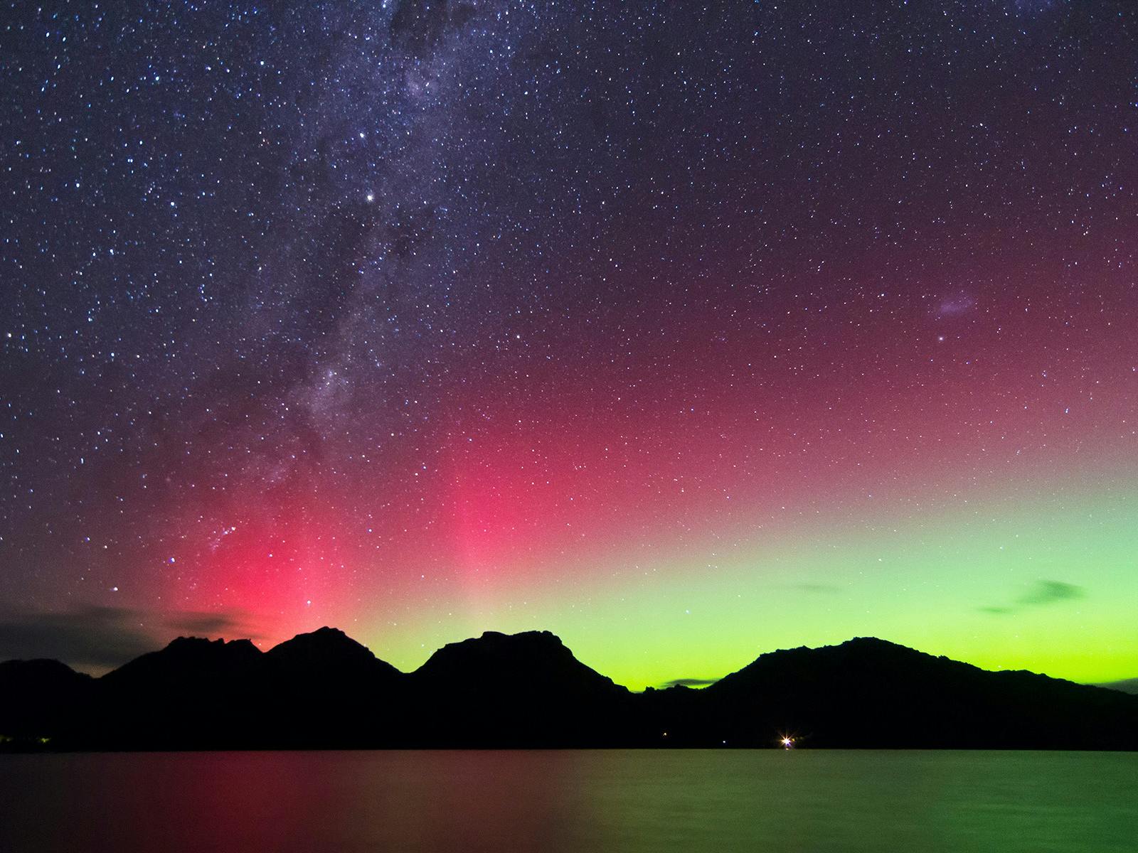 The Aurora Australis, or southern lights, over the Hazards at Freycinet National Park