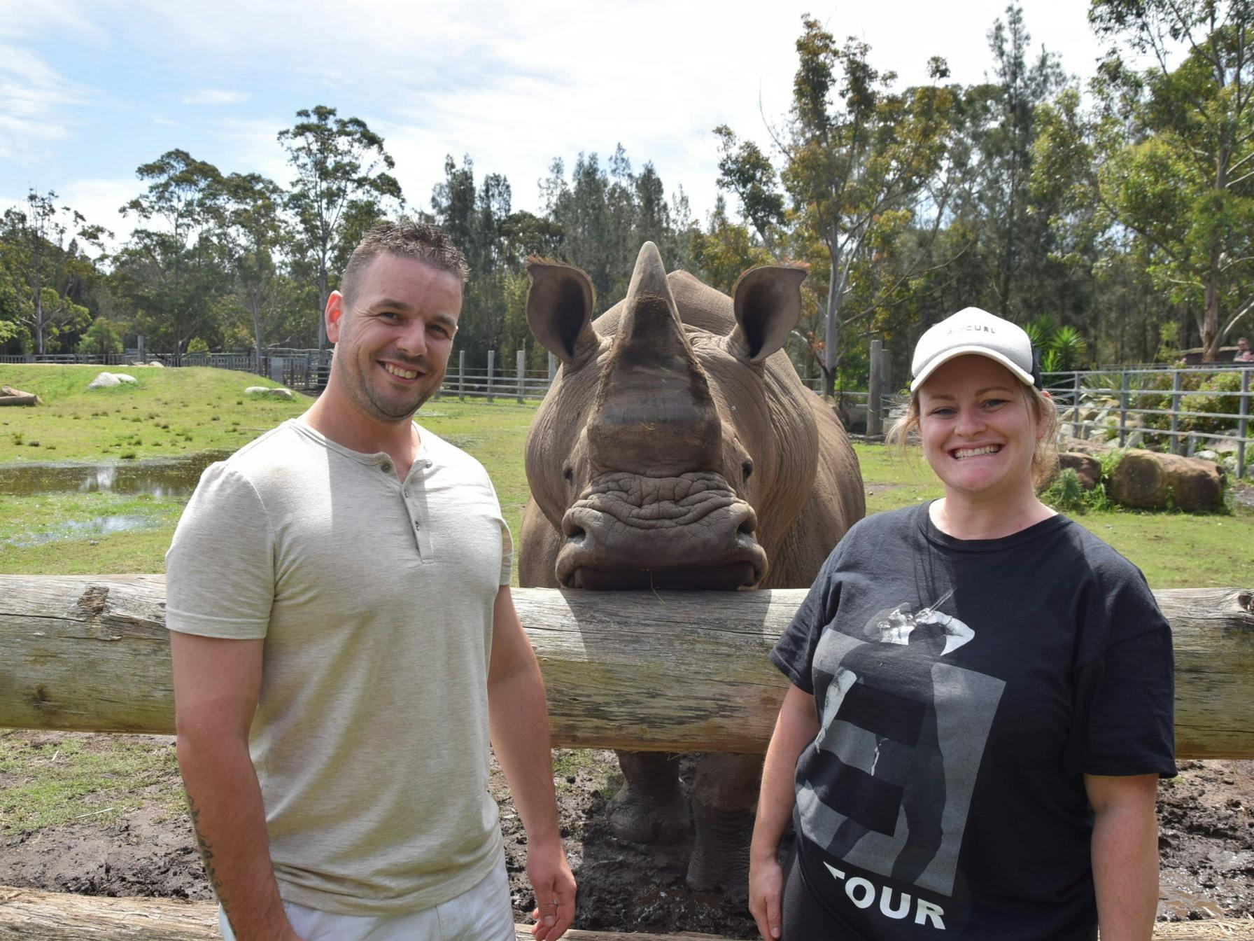 Couple posing with rhino in encounter