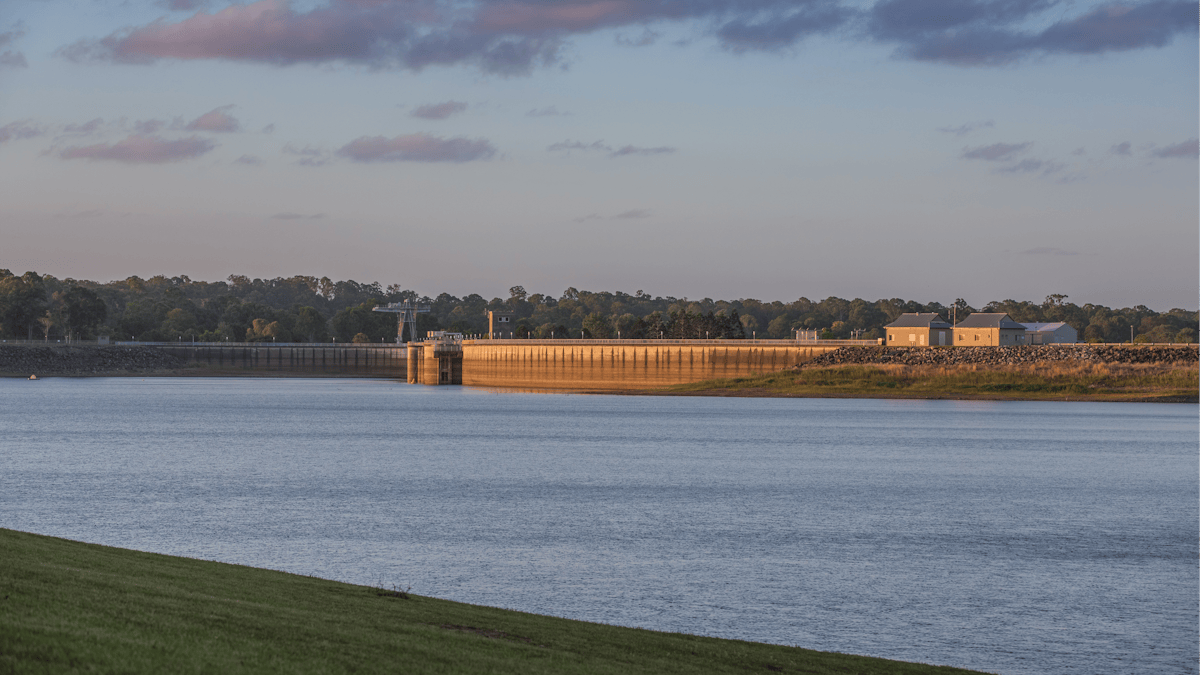 Calm lake water and North Pine Dam Wall at Sunset