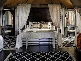 Moroccan inspired black and white interior of the King Deluxe safari tent at Paperbark Camp