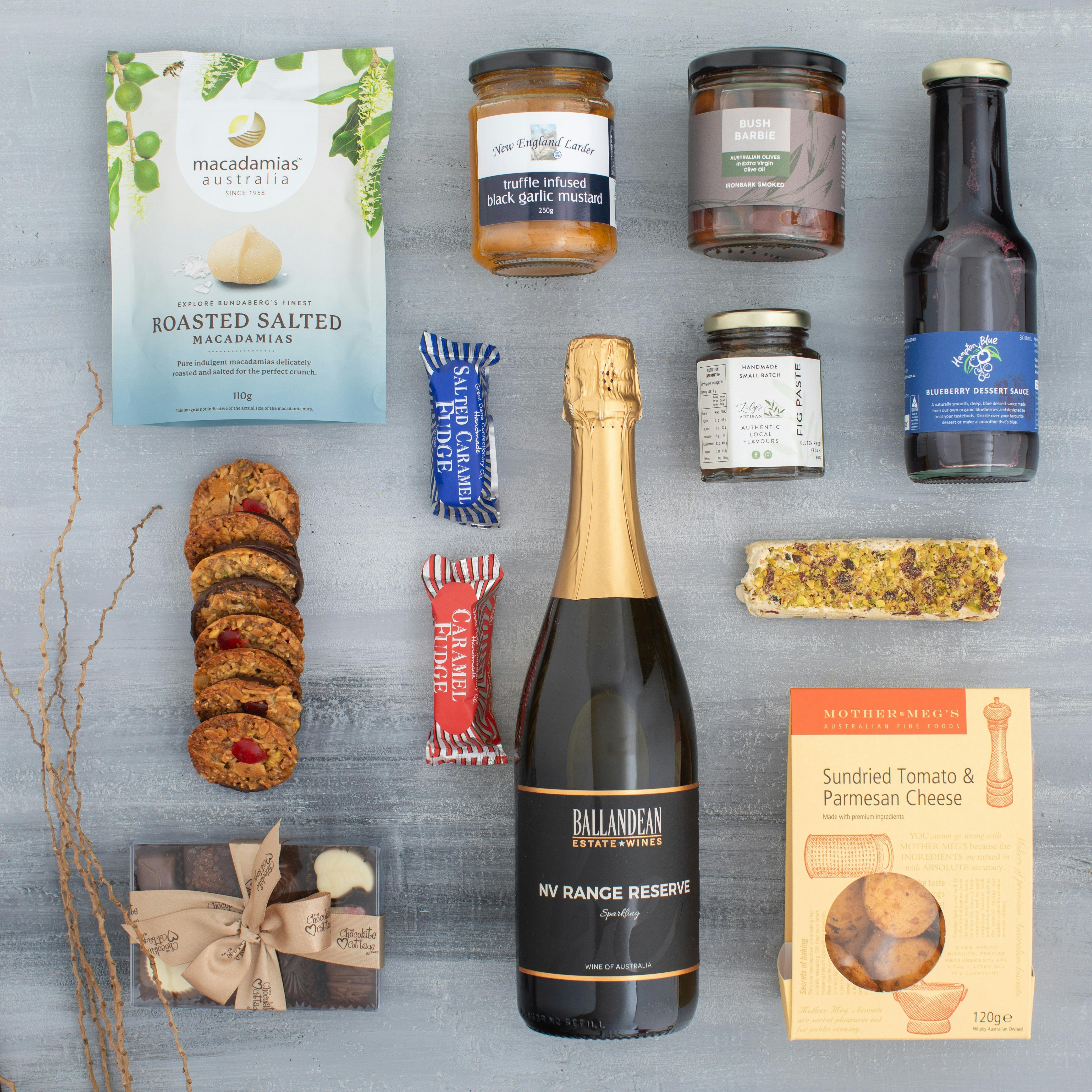 a selection of premium treats including wine, chocolates, savoury snacks, and sweet treats
