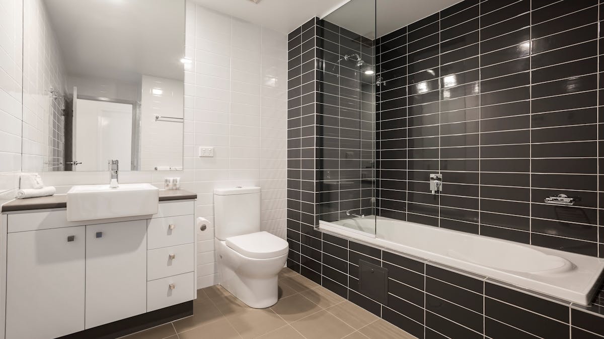 Modern ensuite bathroom with shower over bath tub. Modern ensuite bathroom with shower over bath tub.
