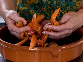 Making a roast carrot salad in a Green Gourmet cooking workshop