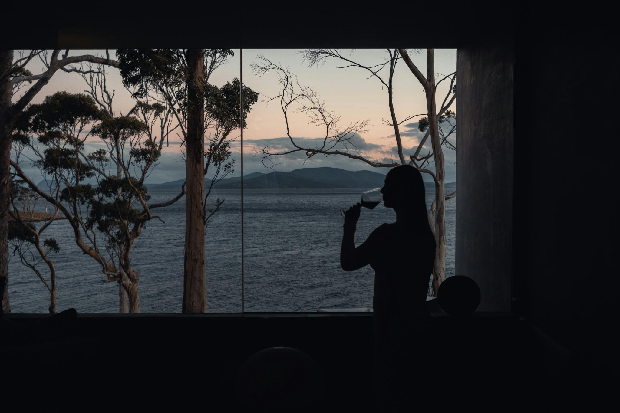 A woman drinking a glass of wine enjoying the view from Tunnel