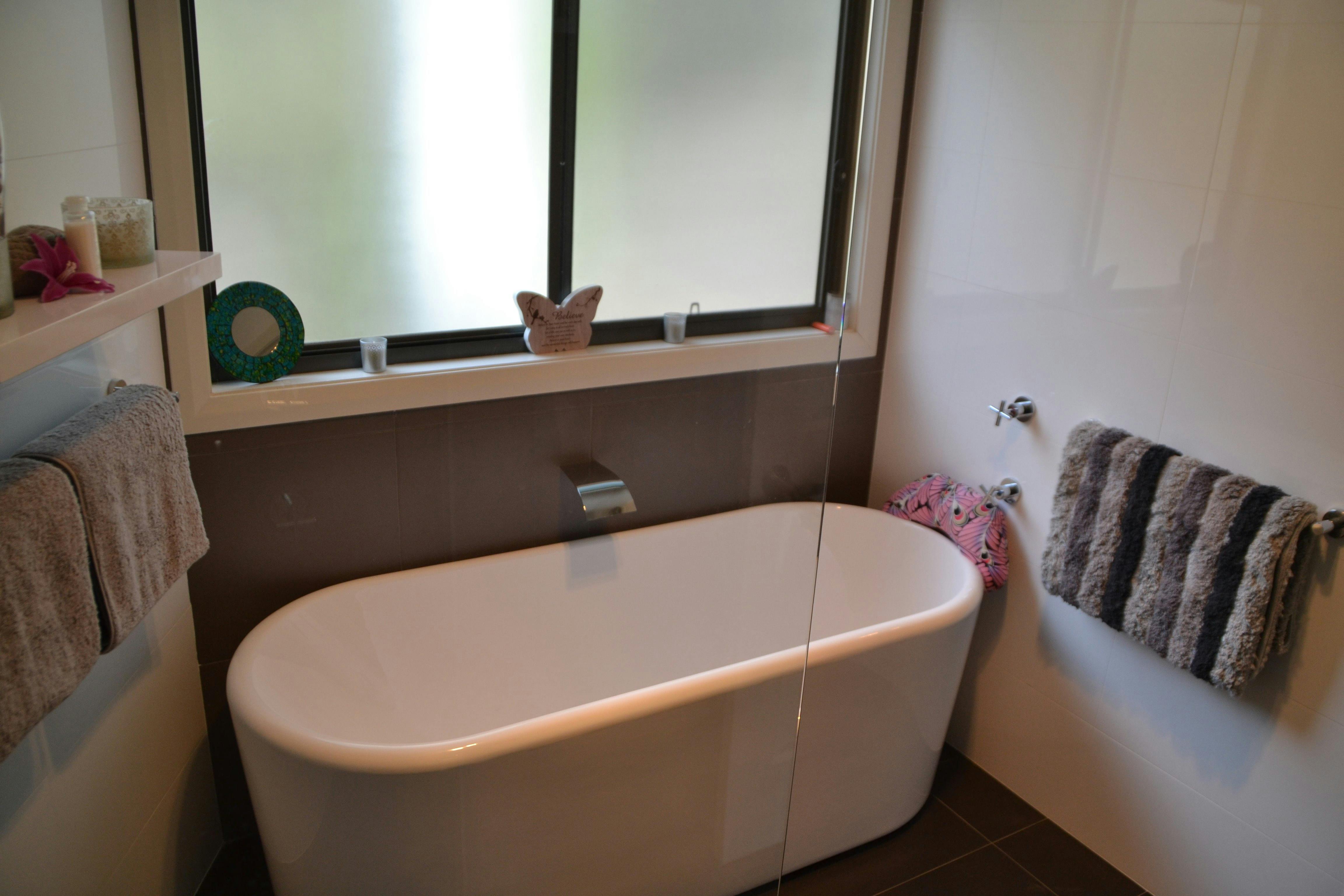 Luxury bathroom, waterfall showerhead, deep bath and candles for that romantic touch