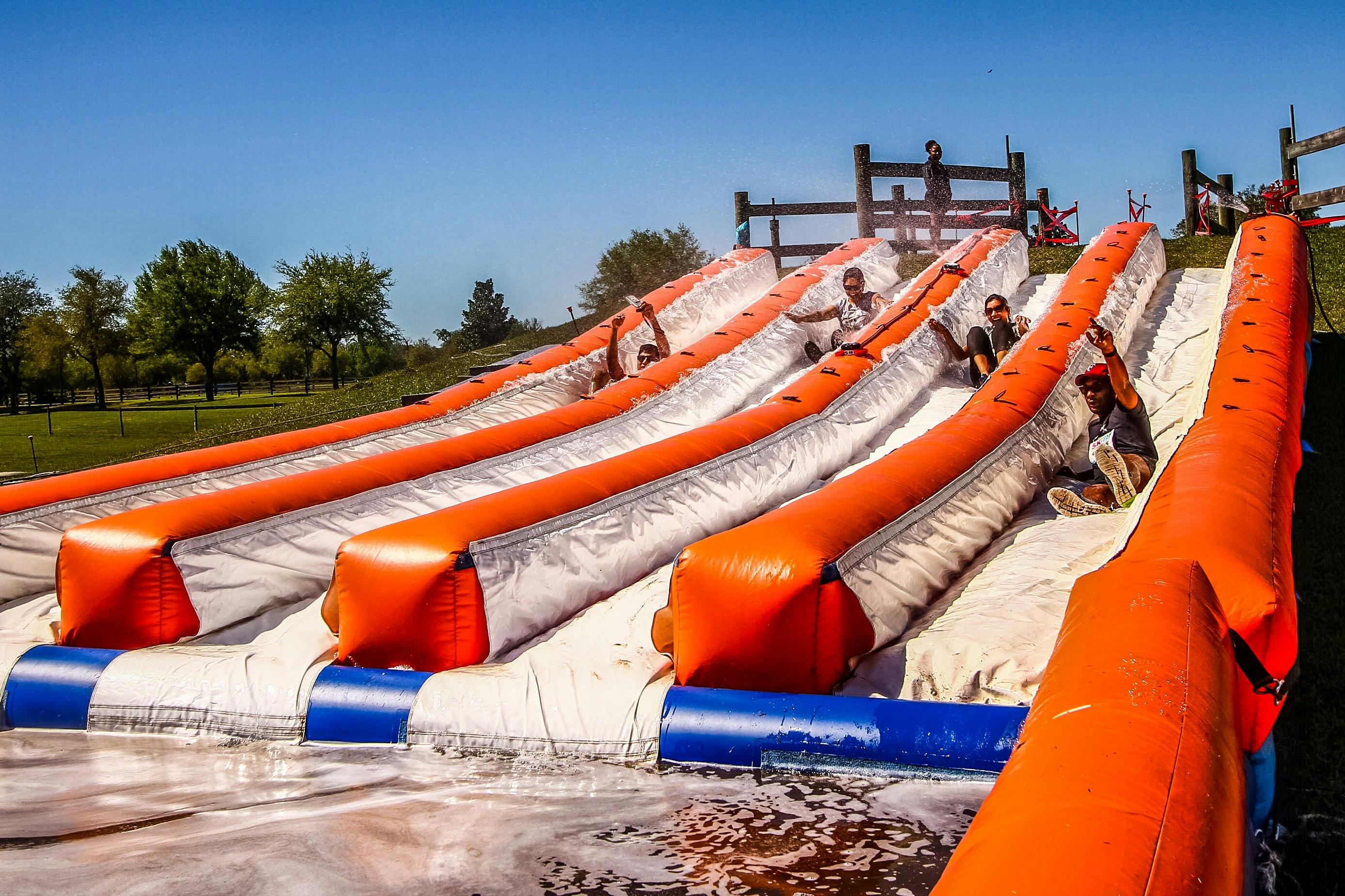 People going down a slip and slide