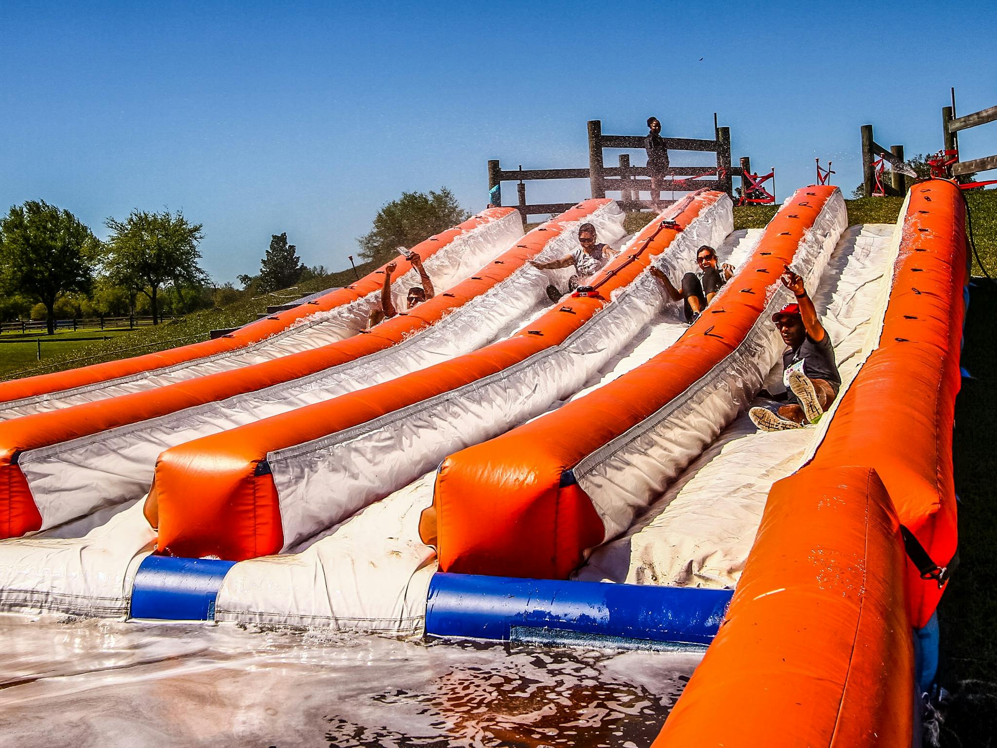 People going down a slip and slide