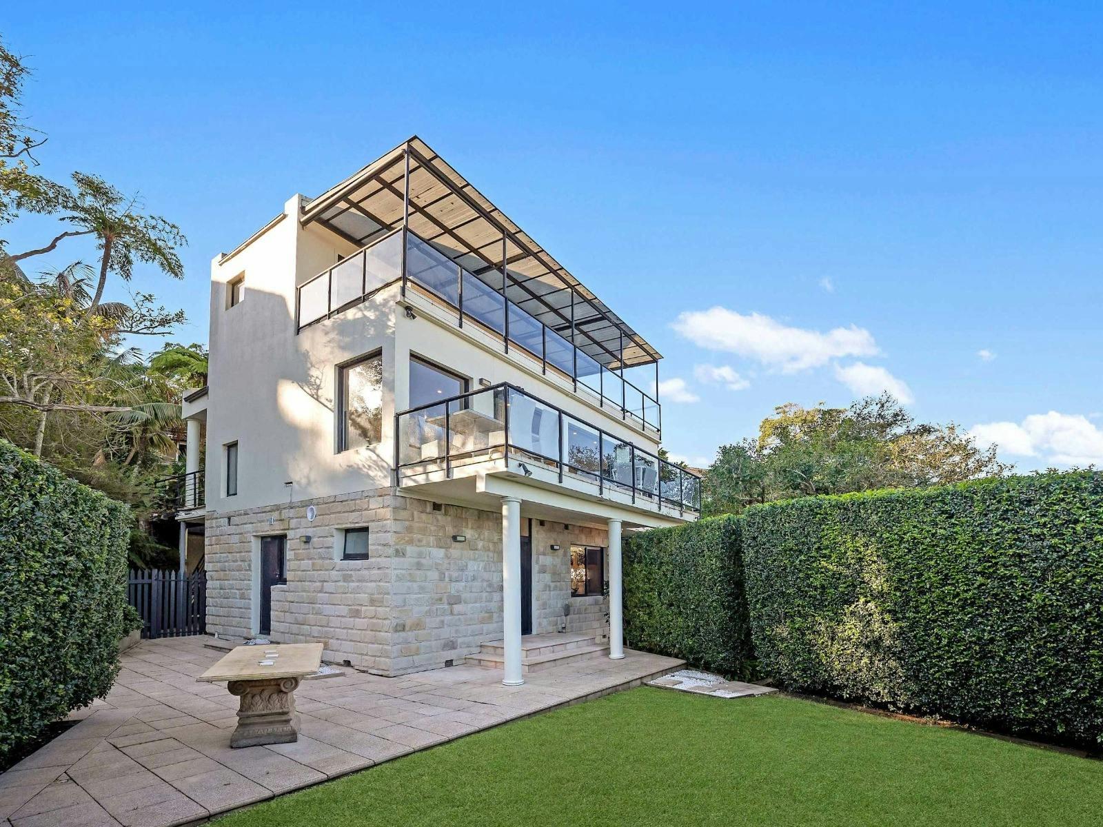 Rear exterior view with lawn area and multi-level structure.