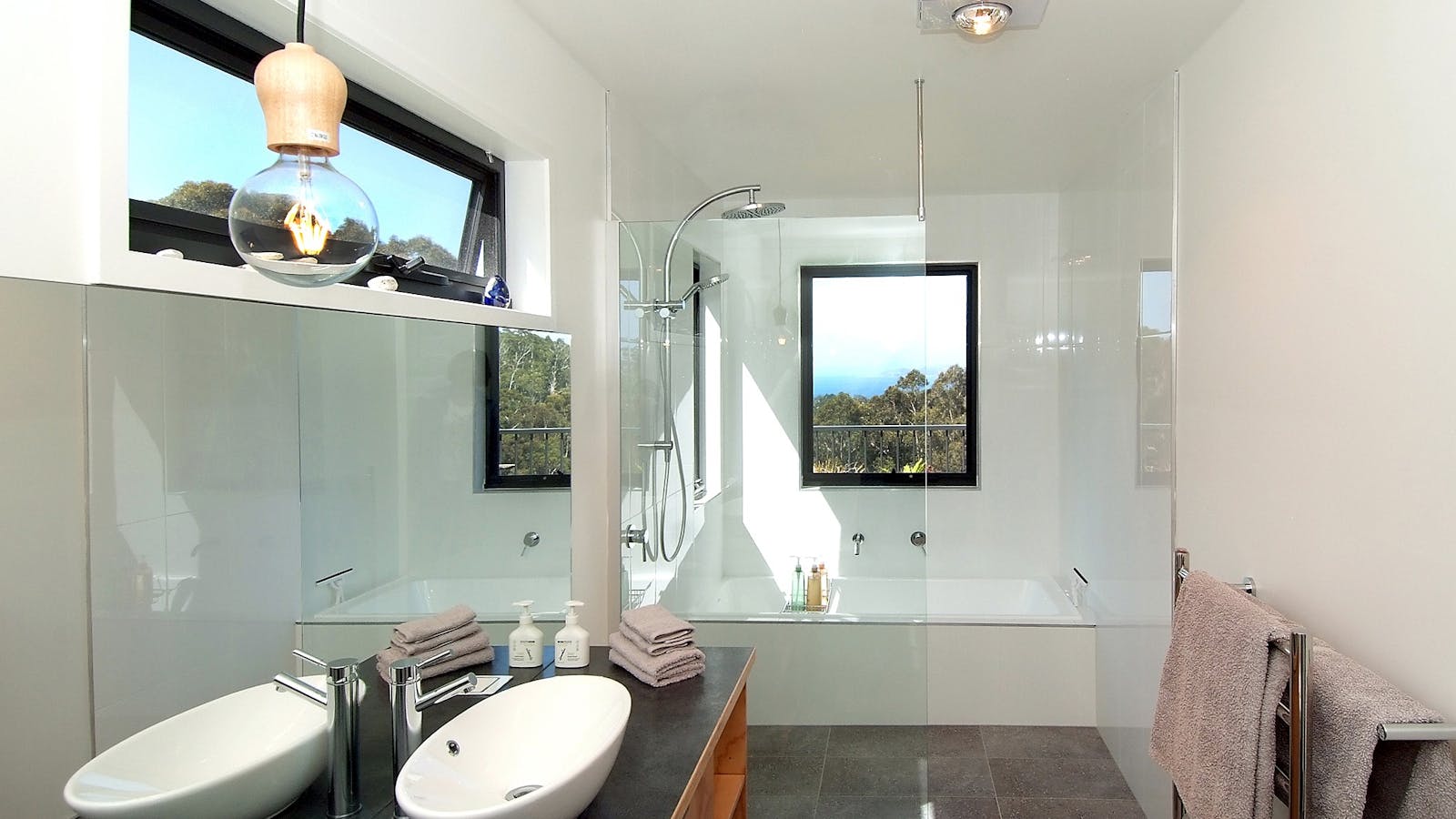 Spacious luxury bathroom with rainshower and bathtub