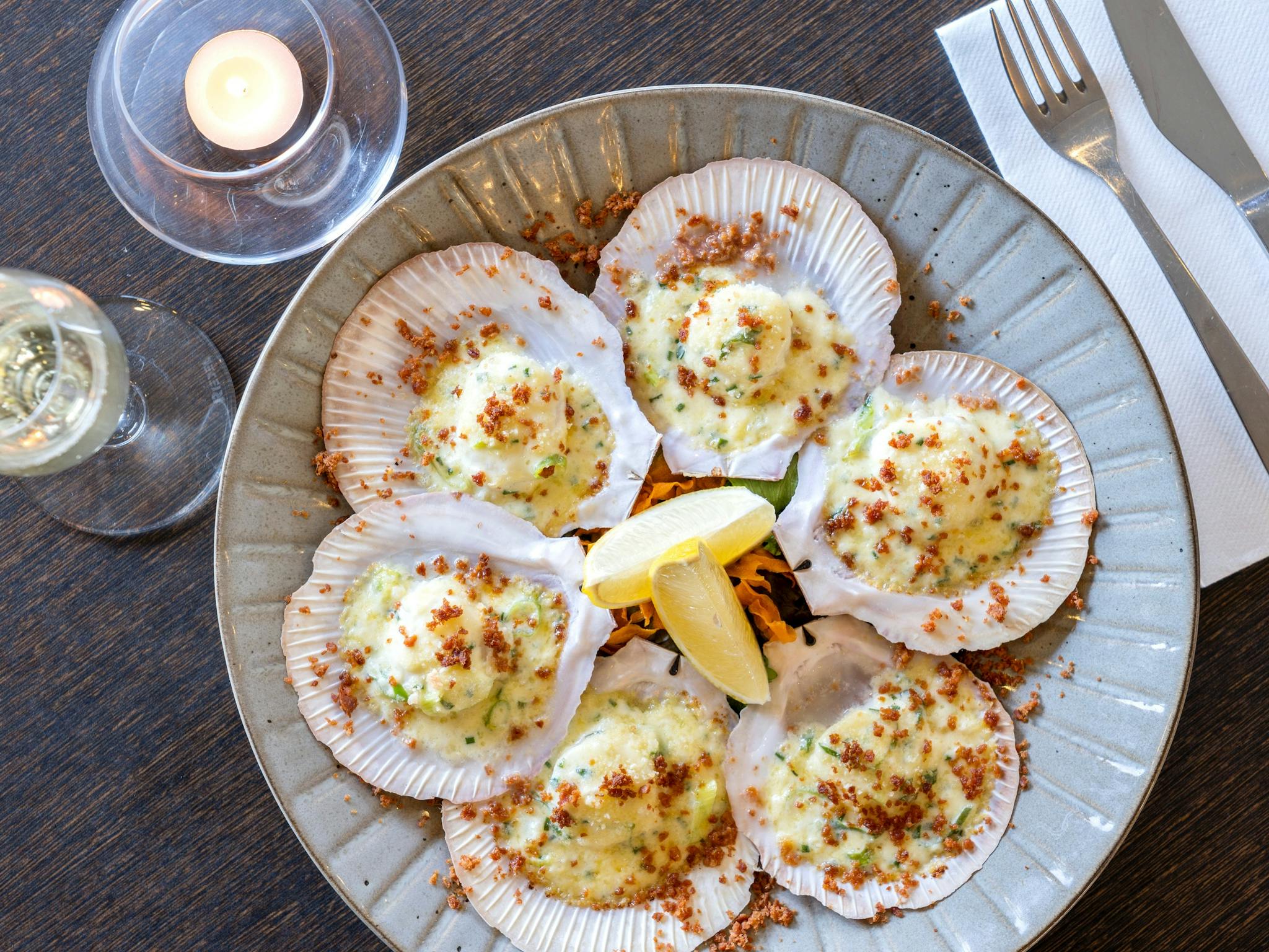 Sea scallops on ½ shell (6), lightly grilled with a garlic cream sauce and topped with chorizo crumb
