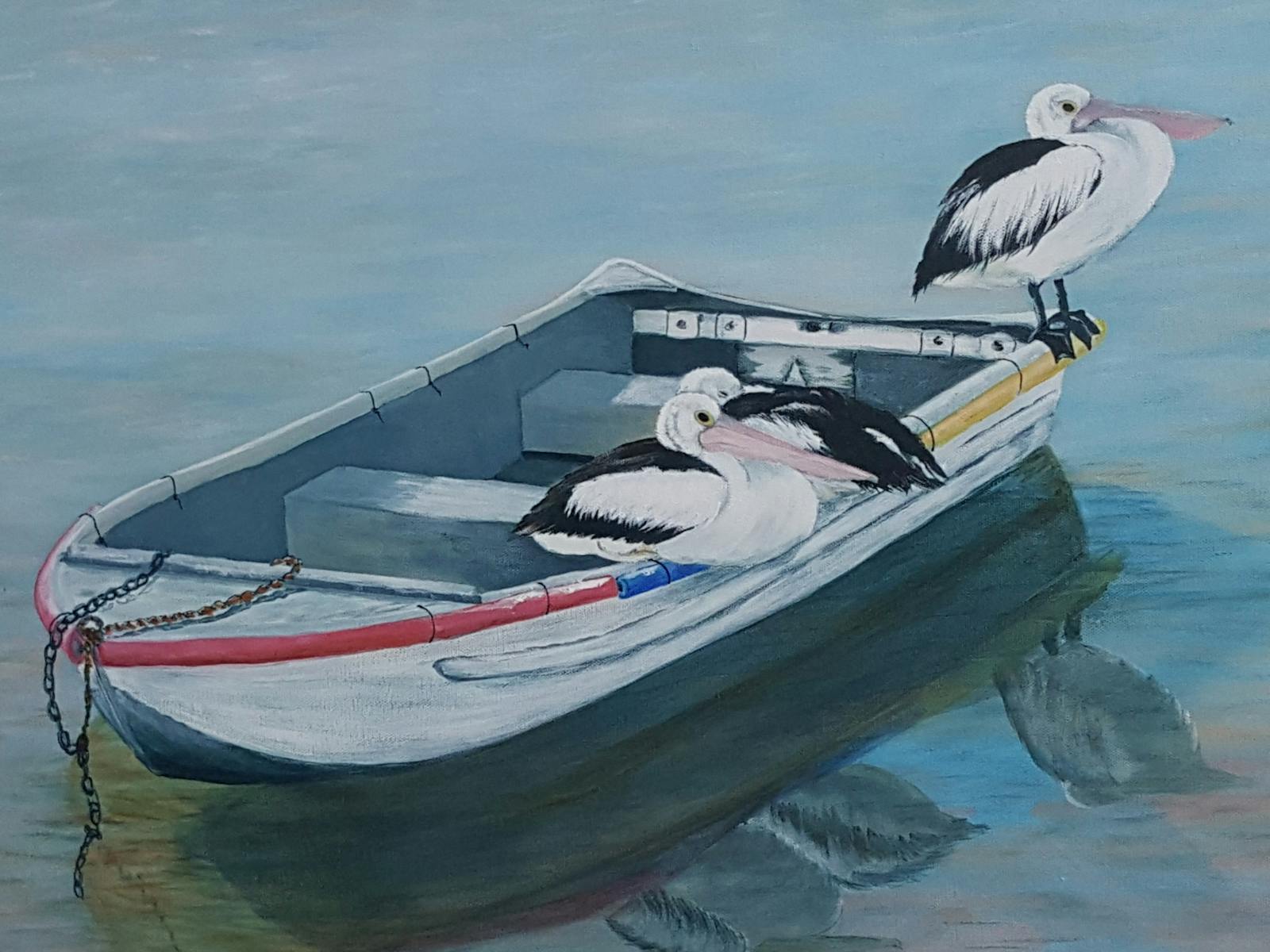 Pelicans resting on a row boat.