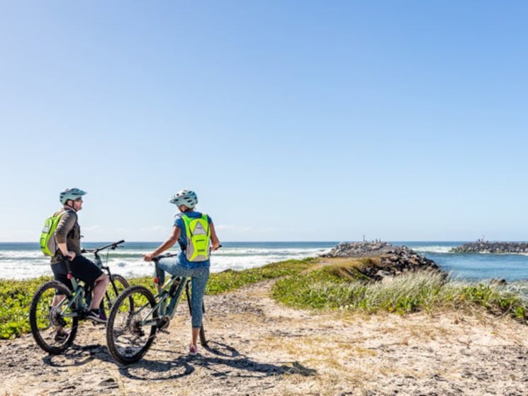Bikers at a coastal breakwall