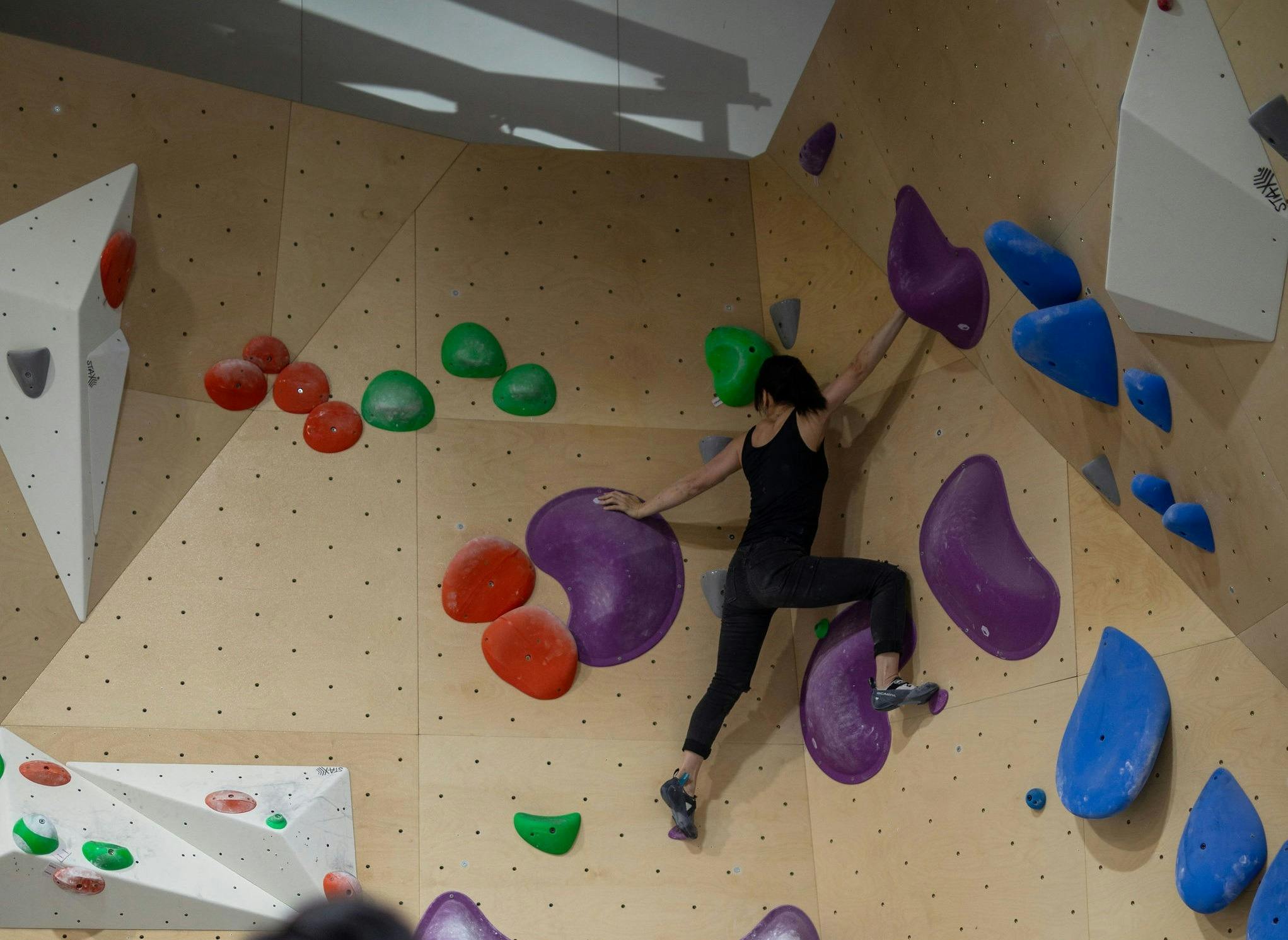 Someone on the climbing wall at Nomad Bouldering