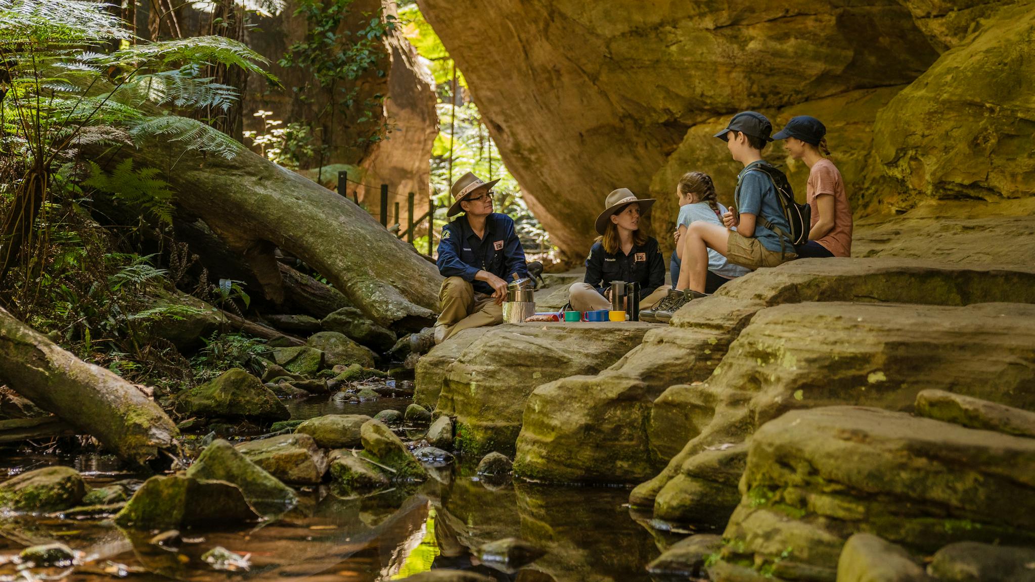 Two tour guides and their guests enjoy a break beside the creek at Ward's Canyon, Carnarvon Gorge. Two tour guides and their guests enjoy a break beside the creek at Ward's Canyon, Carnarvon Gorge.