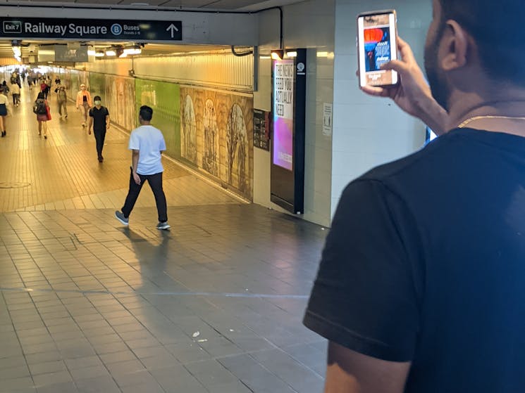 A game participant reading a clue on his mobile phone