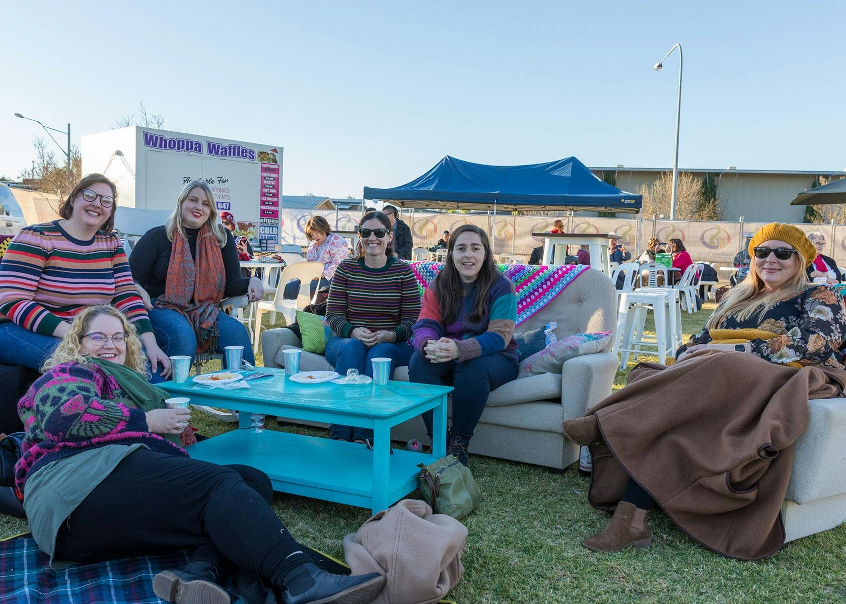 Group enjoying outdoor lounge area, and beverages