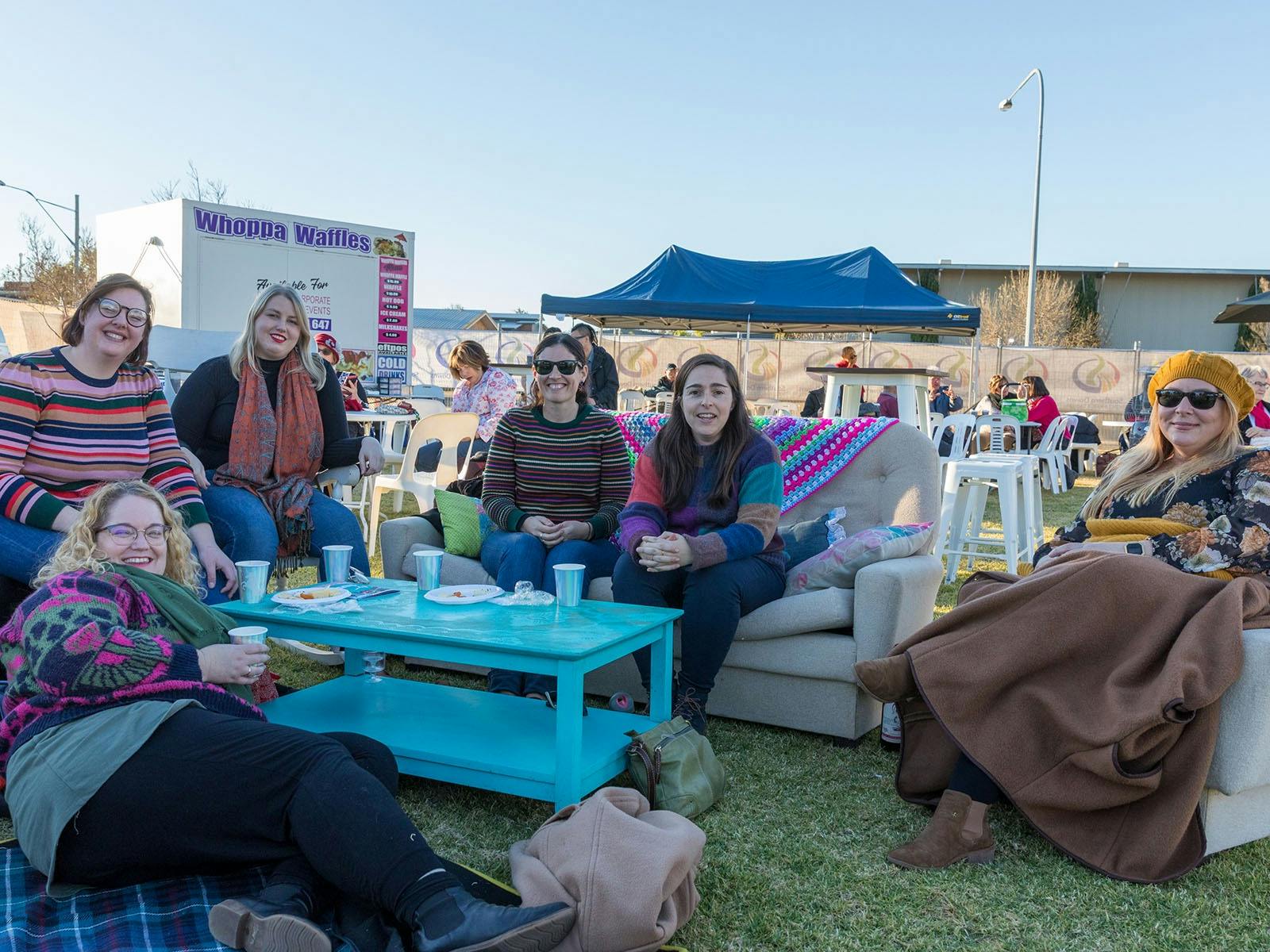 Group enjoying outdoor lounge area, and beverages Group enjoying outdoor lounge area, and beverages