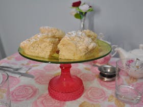 scones on cake stand, pink rose tablecloth