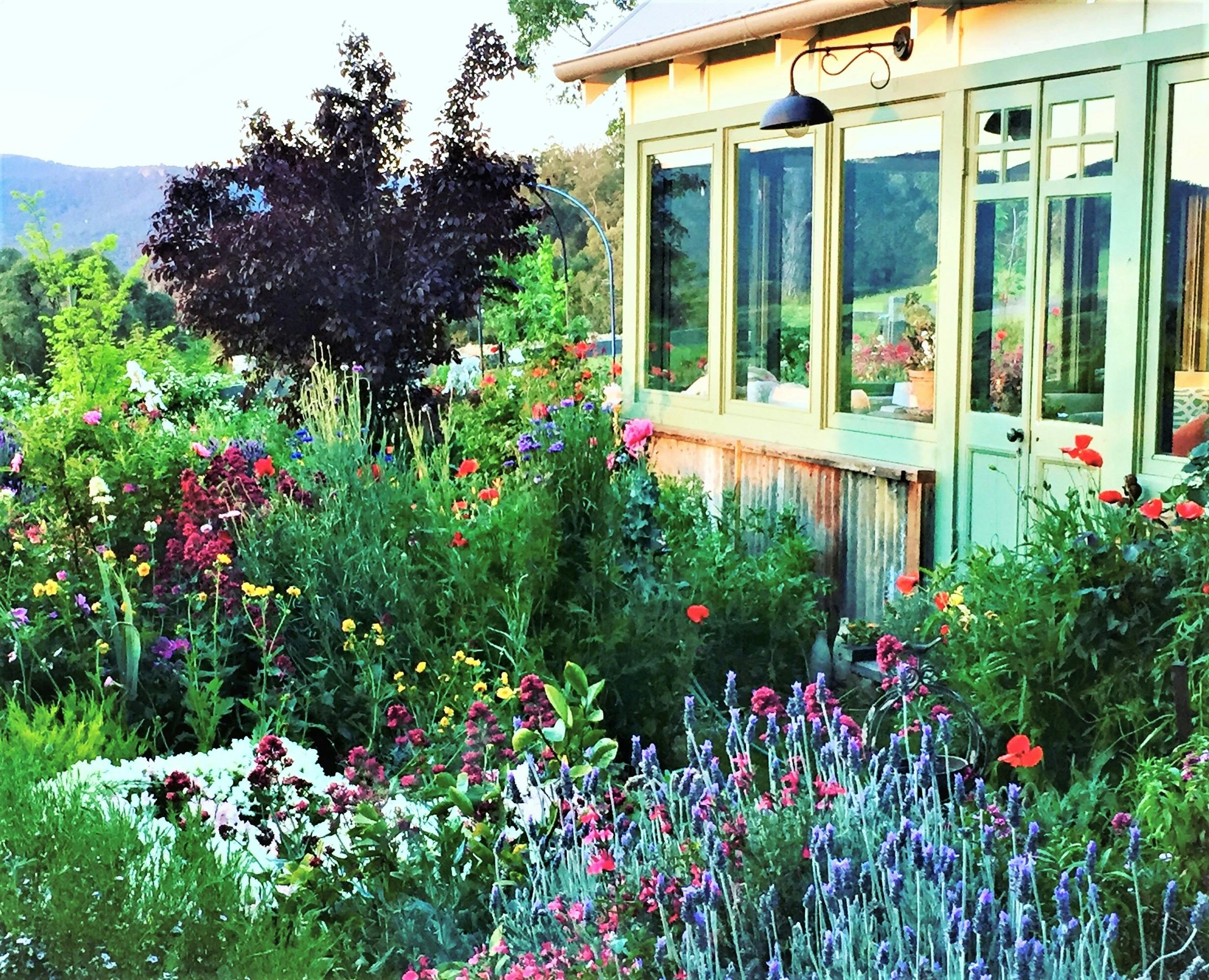 The art studio is surrounded by flowers