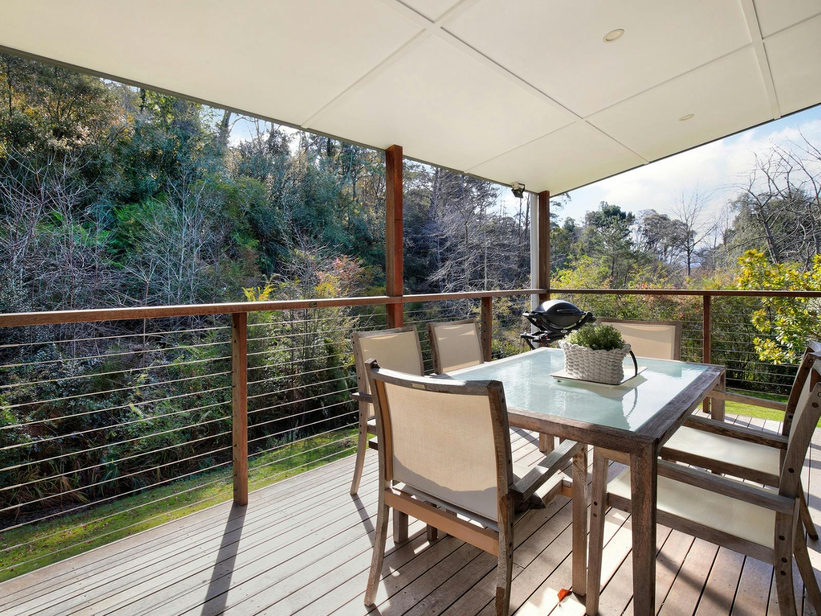 Undercover deck at Creek Cottage with BBQ and outdoor seating