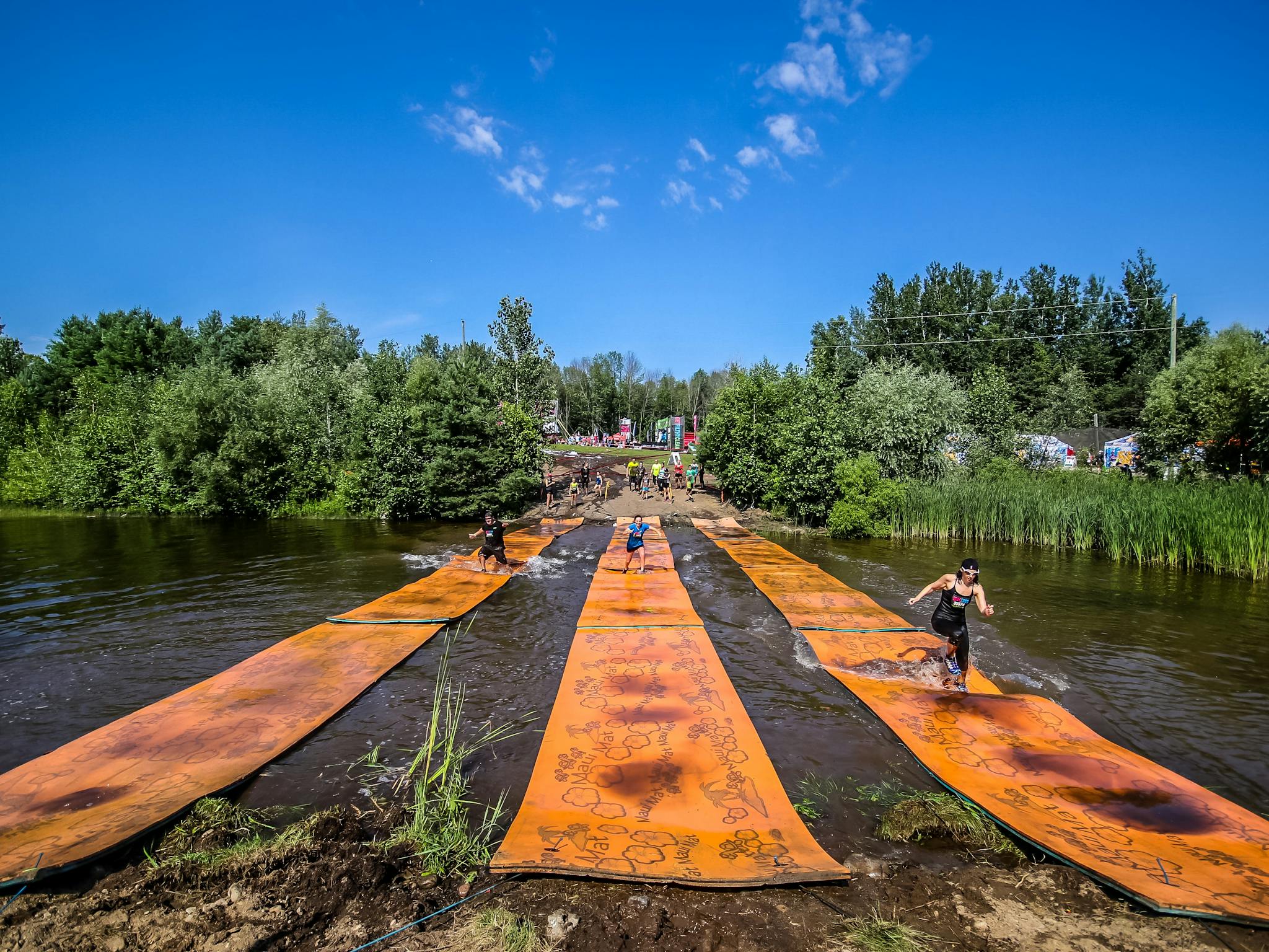 People running over the lily pad obstacle